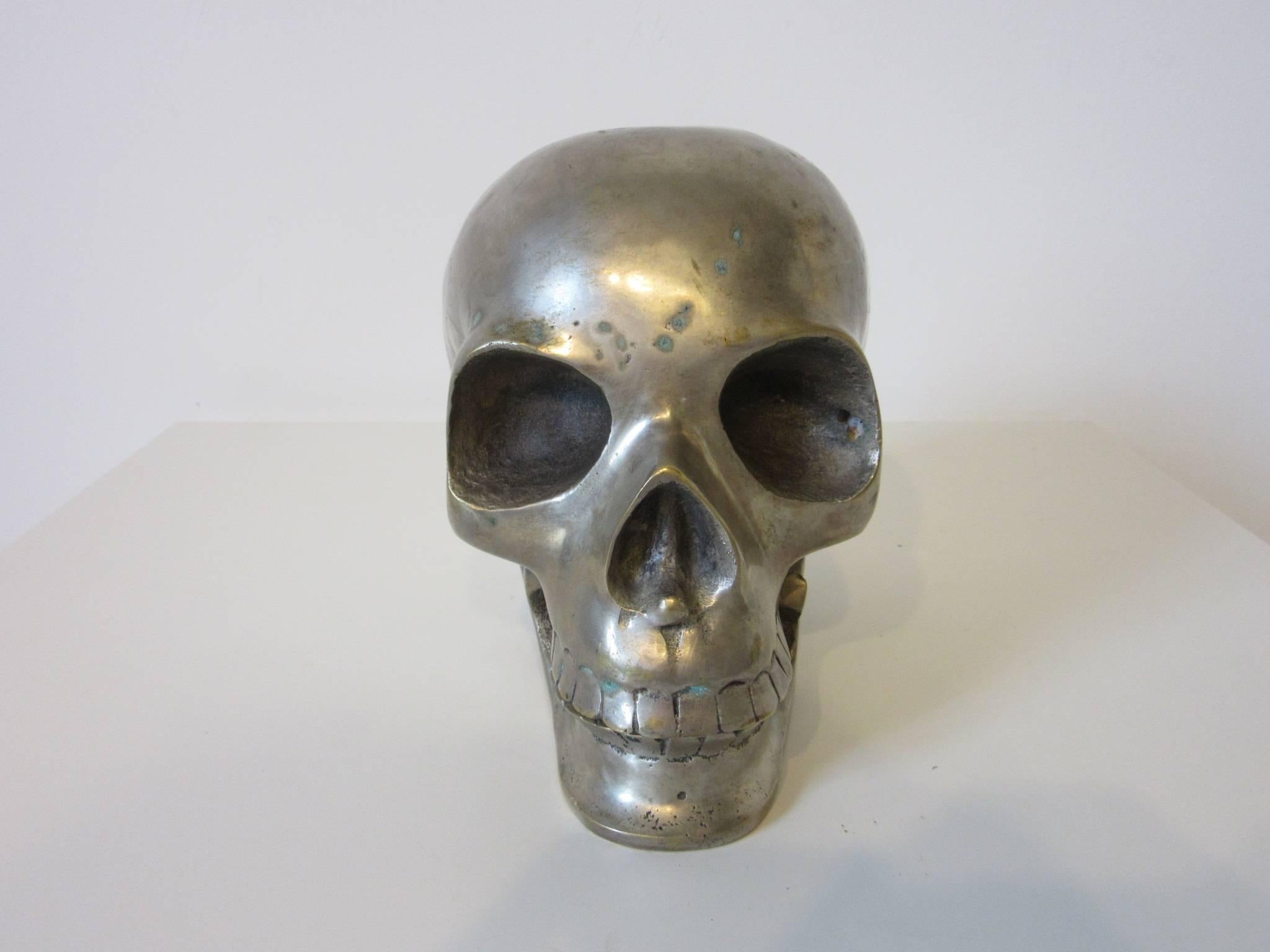 A nickel-plated brass secret society skull used in ceremonies with movable lower jaw, life size
well constructed with great detailing.