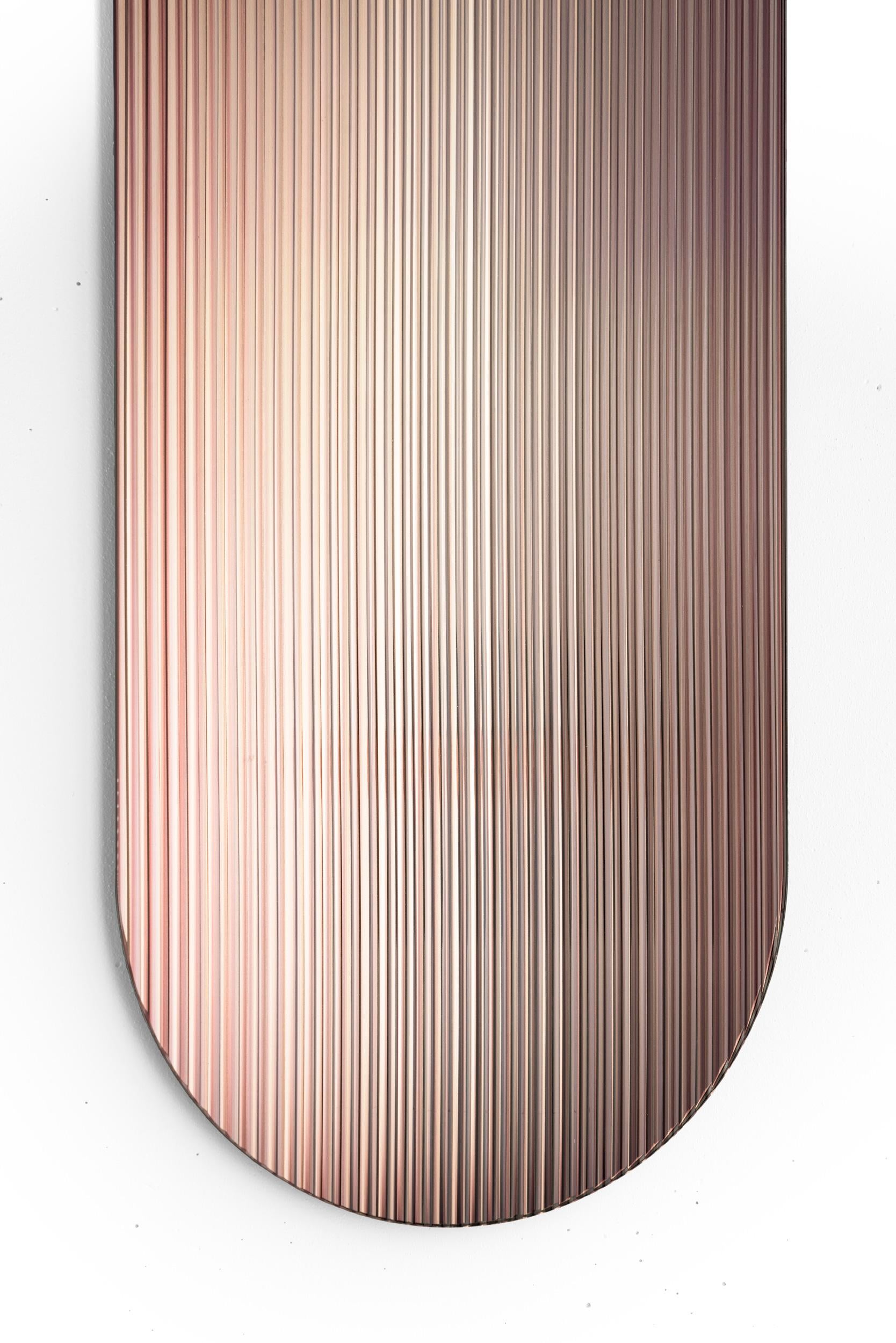 The reflective, coloured, rippled glass panel – designed to add a palette of colour to spaces – reflects light in spaces and adds movement and color whilst creating abstracted reflections. The piece disperses light through its rippled surface