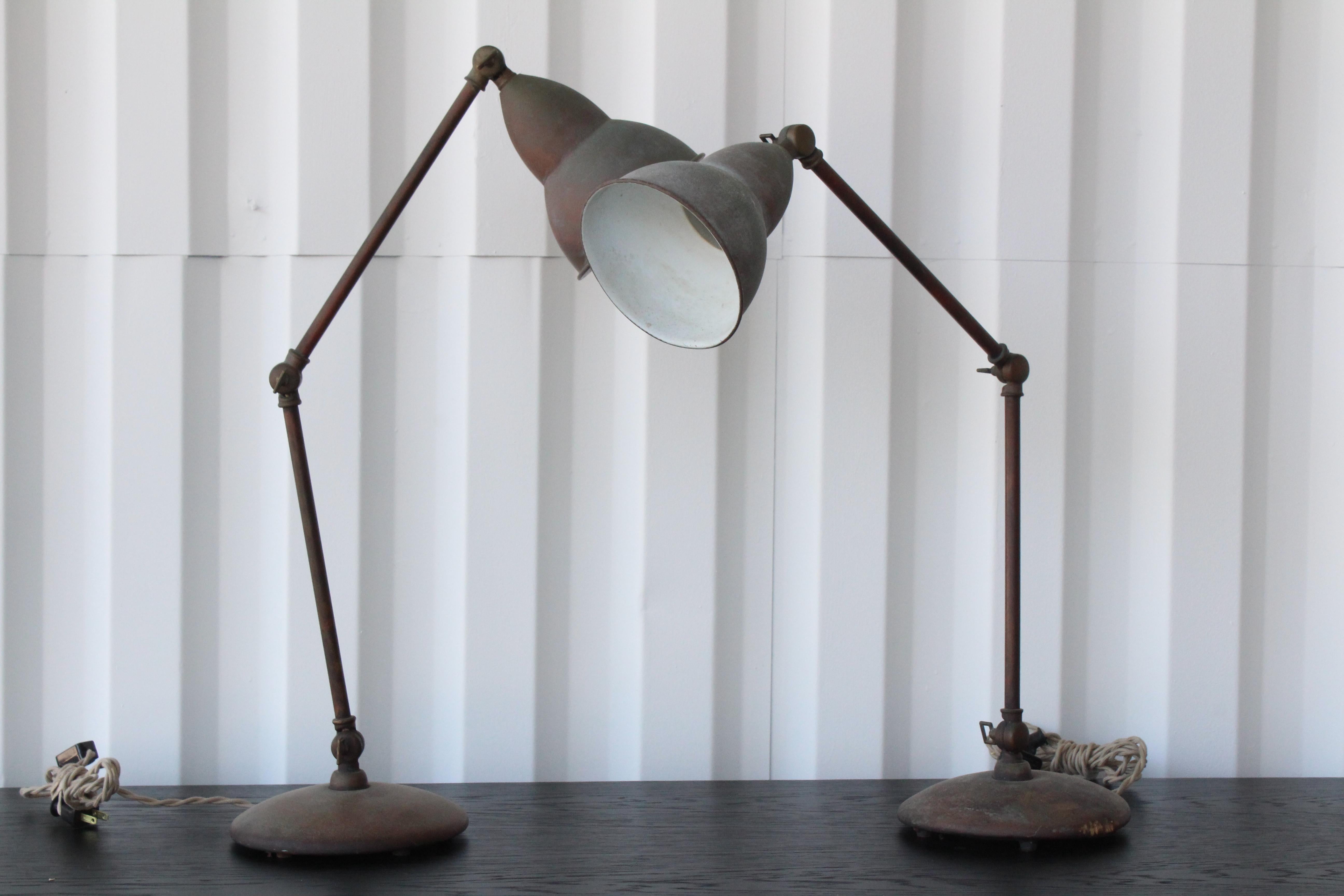 Pair of adjustable metal shop lamps with heavy patina. Pair available, sold individually. Newly rewired.