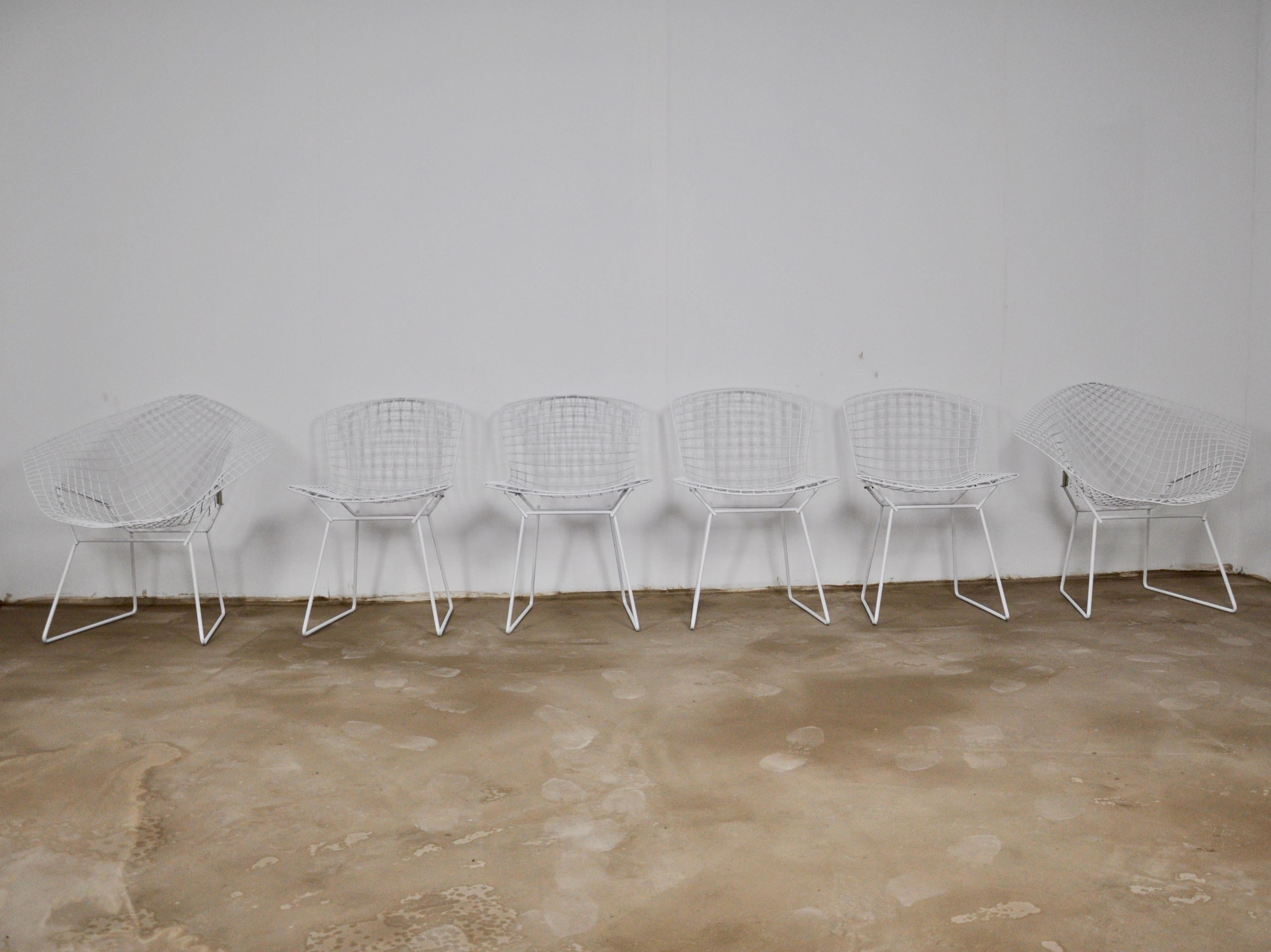 Set of 2 diamond armchairs by Harry Bertoia and 4 white chairs. Seat height 43cm
Chair dimensions: H 76cm, W 53cm, D 53cm.