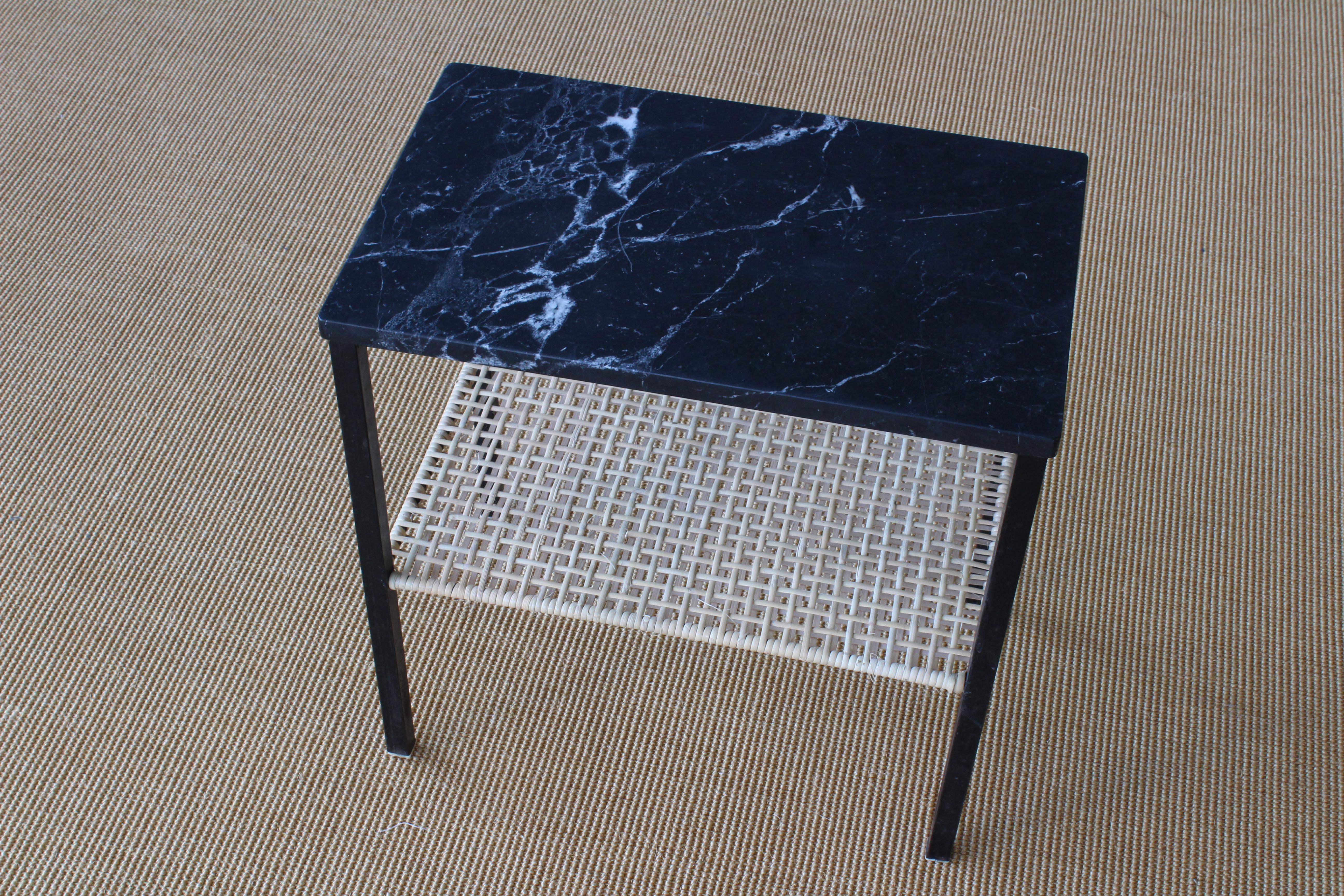 Petite side table with a metal base, new rattan shelf and a marble top.