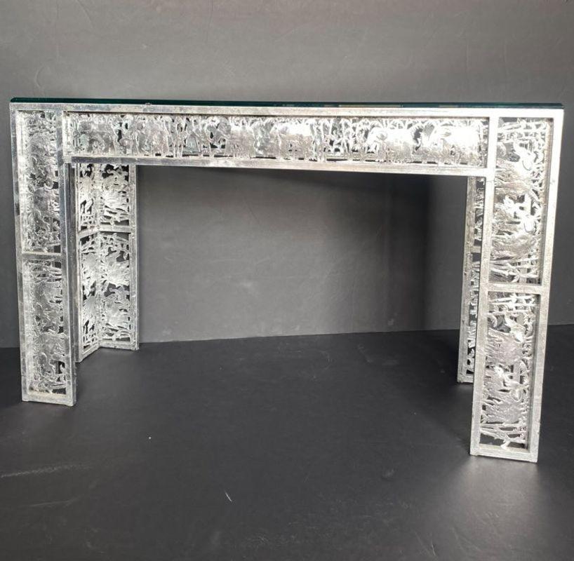 Metal silver leaf finish console with elephant scenes in the jungle and beveled glass on top. 
 
Dimensions:
 
33