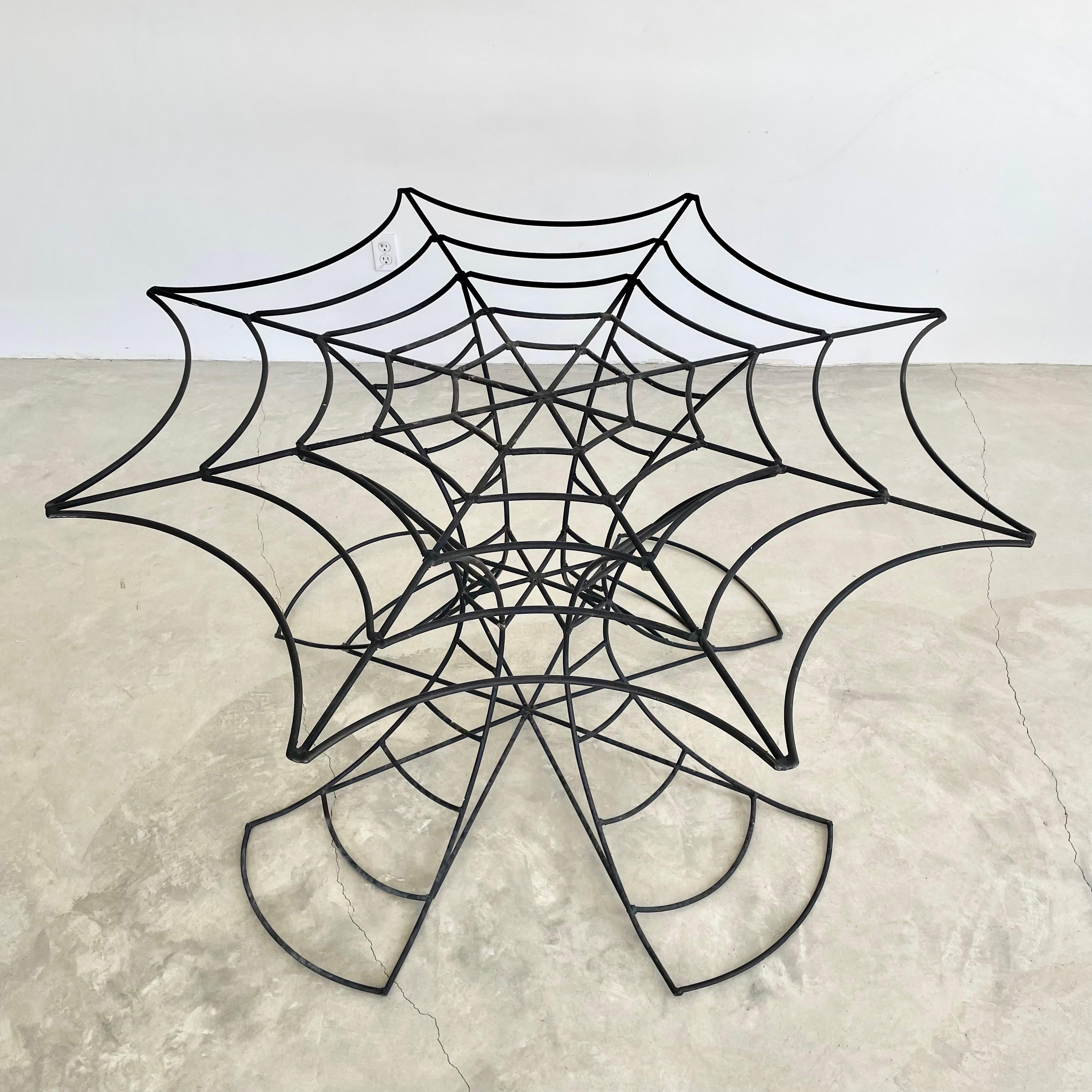 Incredibly unique welded metal table in the design of a massive spider web.Great attention to detail with bends of each metal bar lining up perfectly around the whole table. Base is made up of four metal fan legs that spread out at the base giving