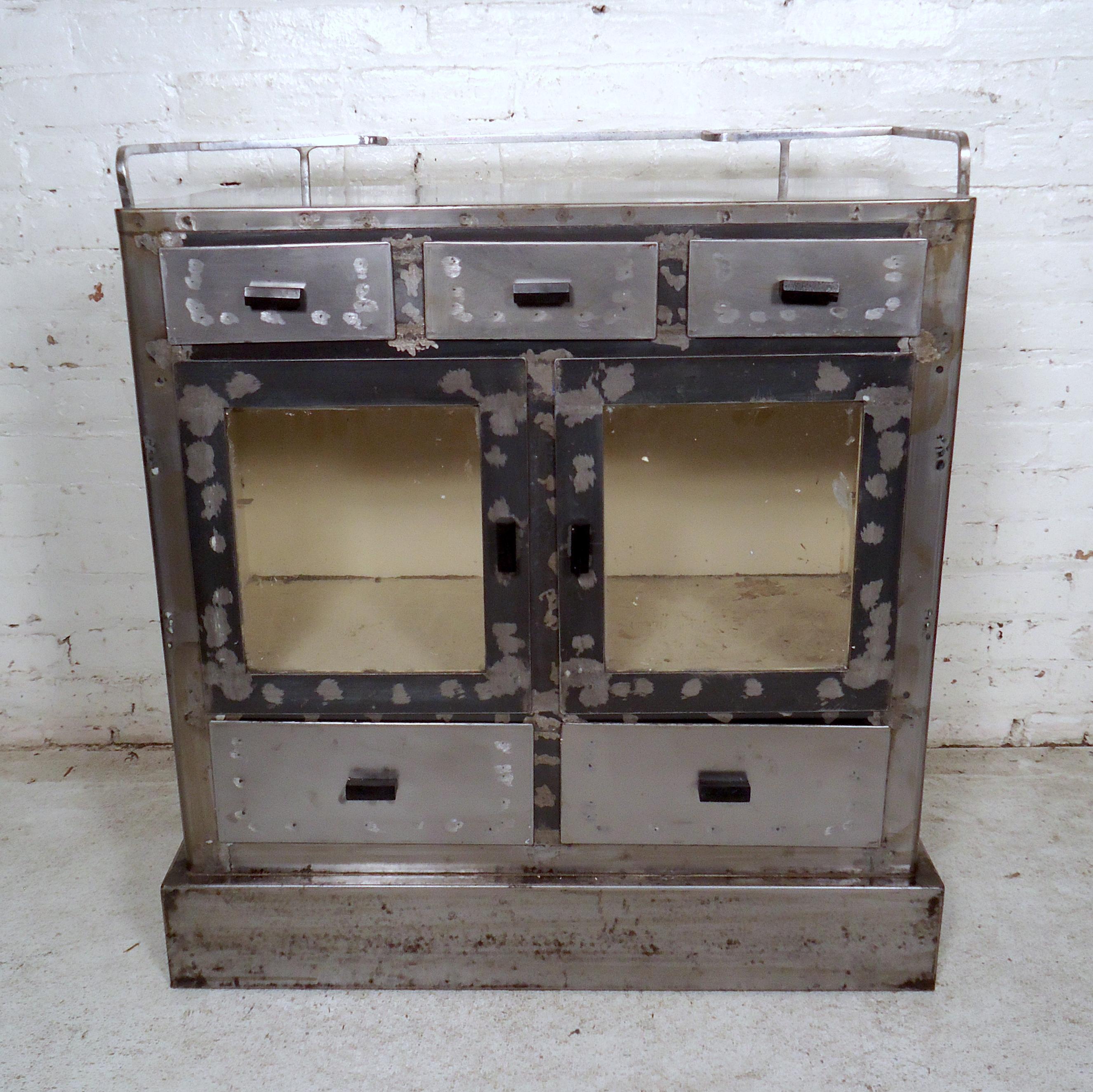 Vintage metal cabinet with ample storage, refinished in a bare metal style. Unique side cabinets and drawers, casters, top railing. Great for kitchen or bathroom use.

(Please confirm item location - NY or NJ - with dealer).