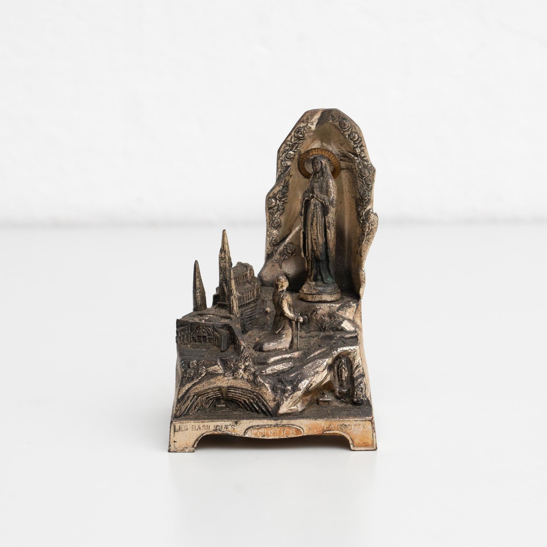 Miracle du cierge' Lourde metallic virgin statue.    Made France, circa 1950.    In original condition, with minor wear consistent with age and use, preserving a beautiful patina.    Materials:  Metal