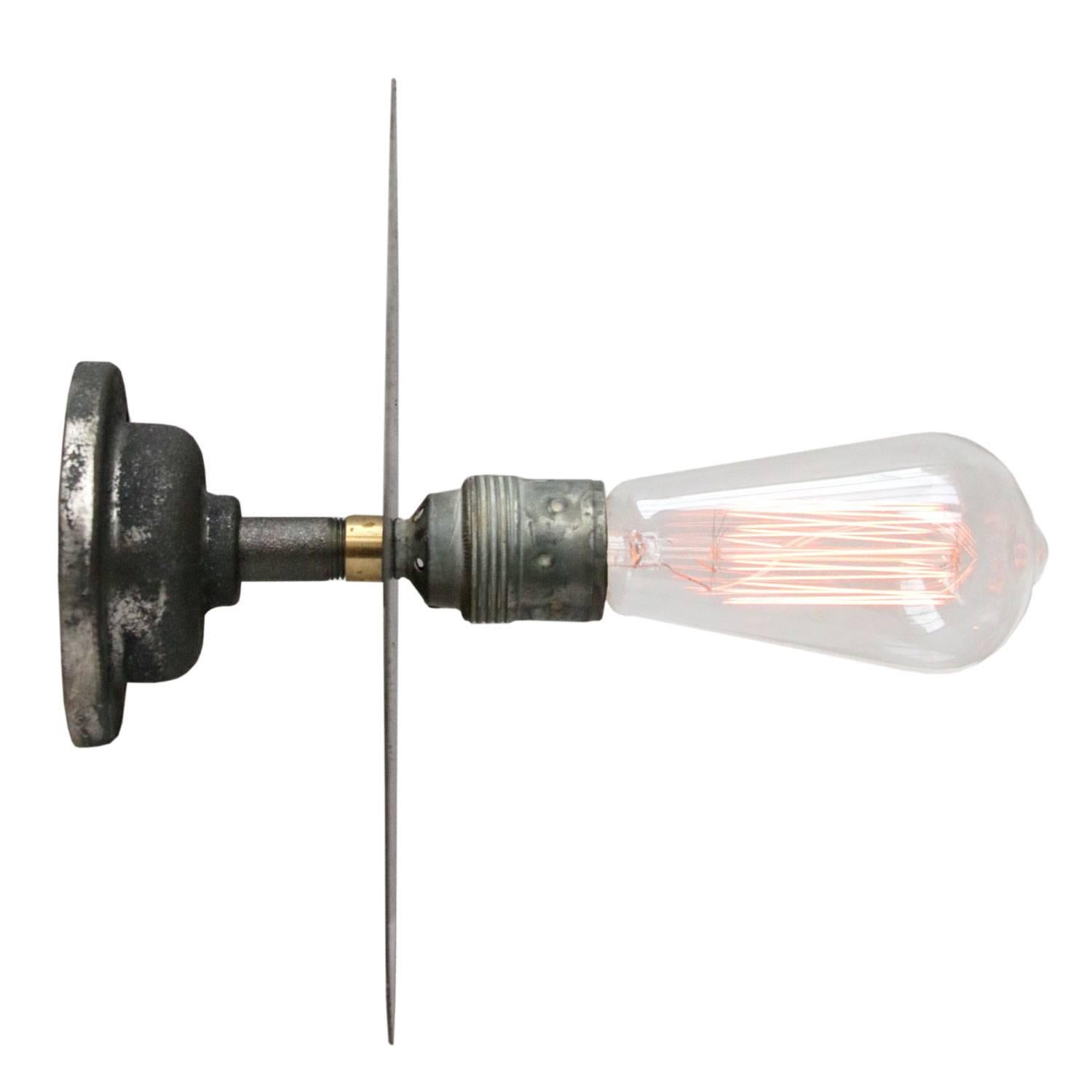 Metal wall lamp / scone.
Cast iron wall piece. Metal bulb holder with flat metal plate.

Weight: 0.8 kg / 1.8 lb

All lamps have been made suitable by international standards for incandescent light bulbs, energy-efficient and LED bulbs. E26/E27 bulb