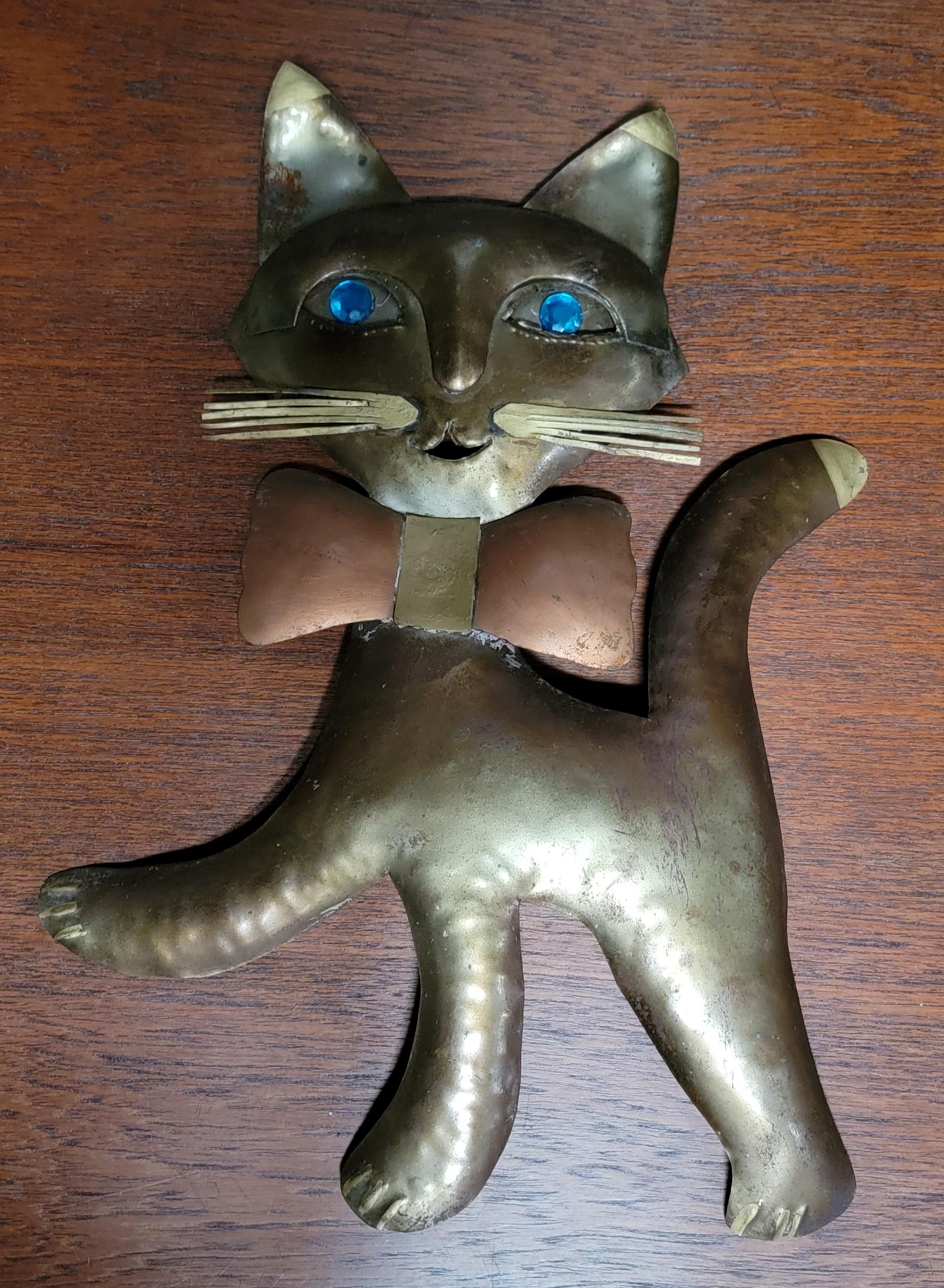 Brass and copper wall sculpture in the style of Jere. Jeweled eyes. Measures 13.25 inches tall. Very good original condition.