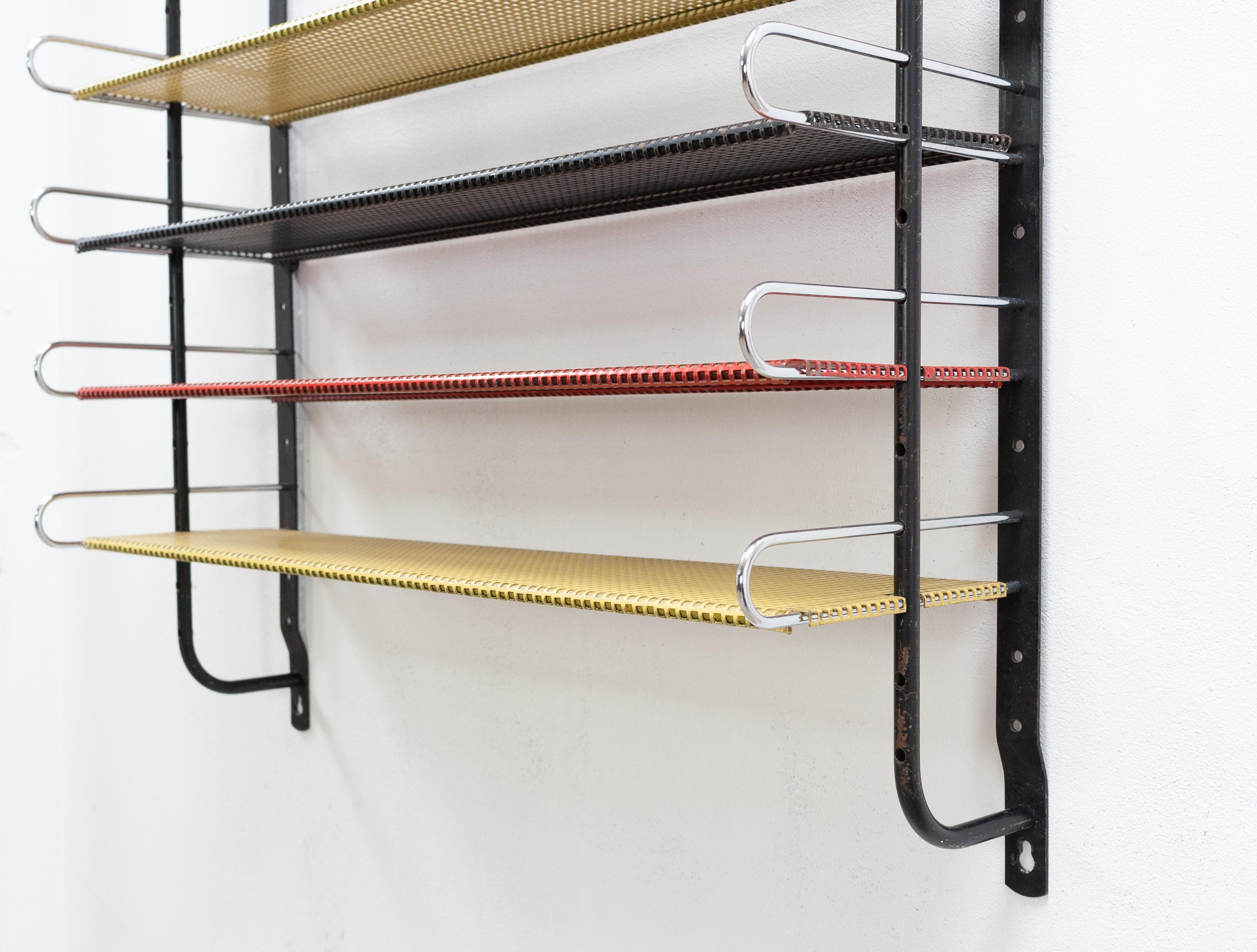 Very nice designed metal wall unit. Solid metal. 6 Perforated shelves and, chrome brackets. All original primary colors.