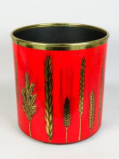 Metal wastebasket with a gold herringbone design and red lacquered base