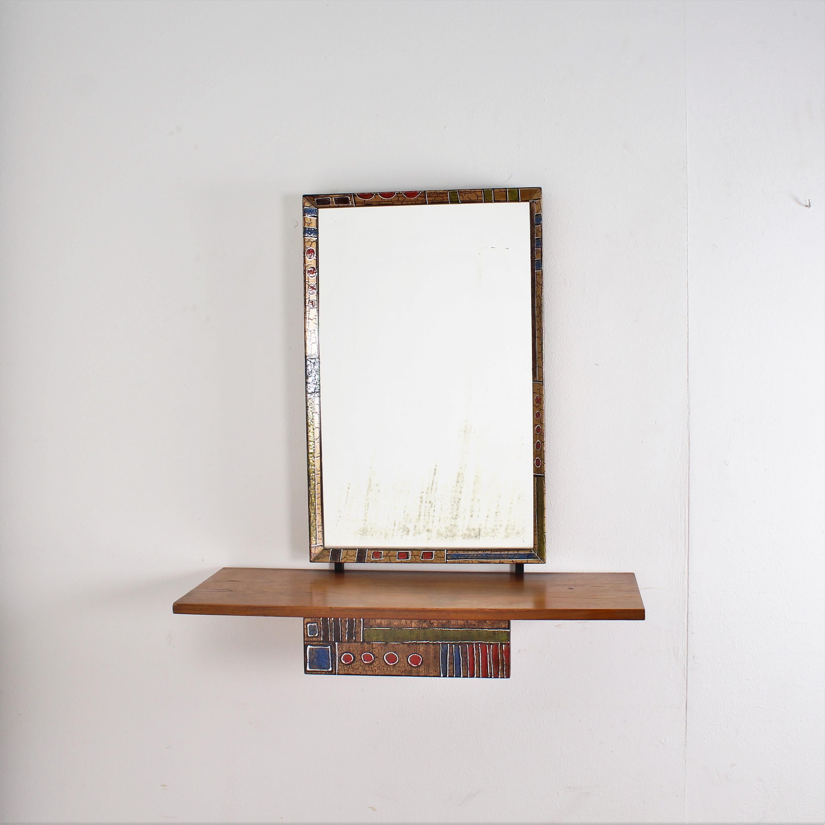 Original beautiful metal wooden console with rectangular wall mirror framed by an enameled metal profile by Esperia, Italy, 1960s.
The design of the structure is enlivened by a small drawer with decorations with polychrome enamels on the front