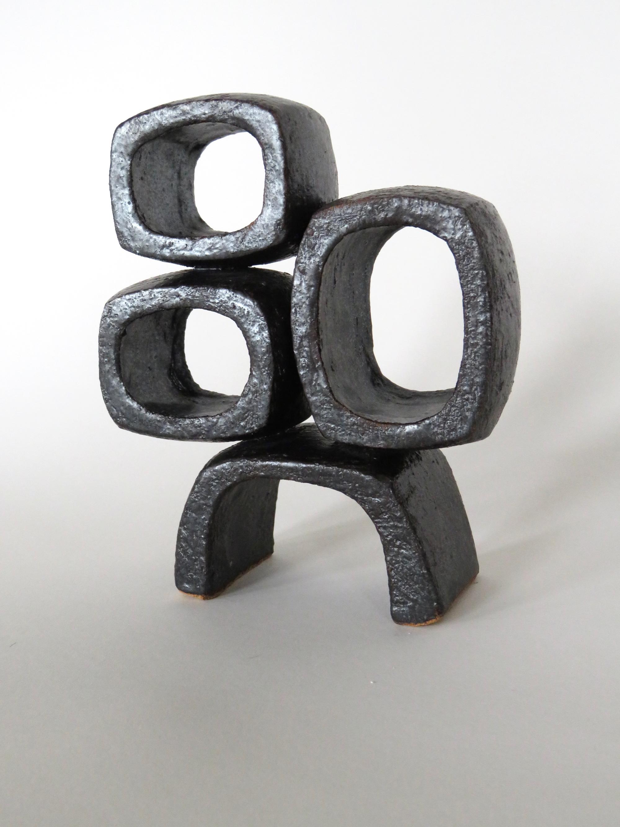 Metallic gray-black ceramic sculpture with three rectangular rings standing on a rectangular arc'd base. Formed completely by hand. High-fired in a gas kiln, truly one of a kind as the clay for this glaze is no longer mined. A modern TOTEM, part of