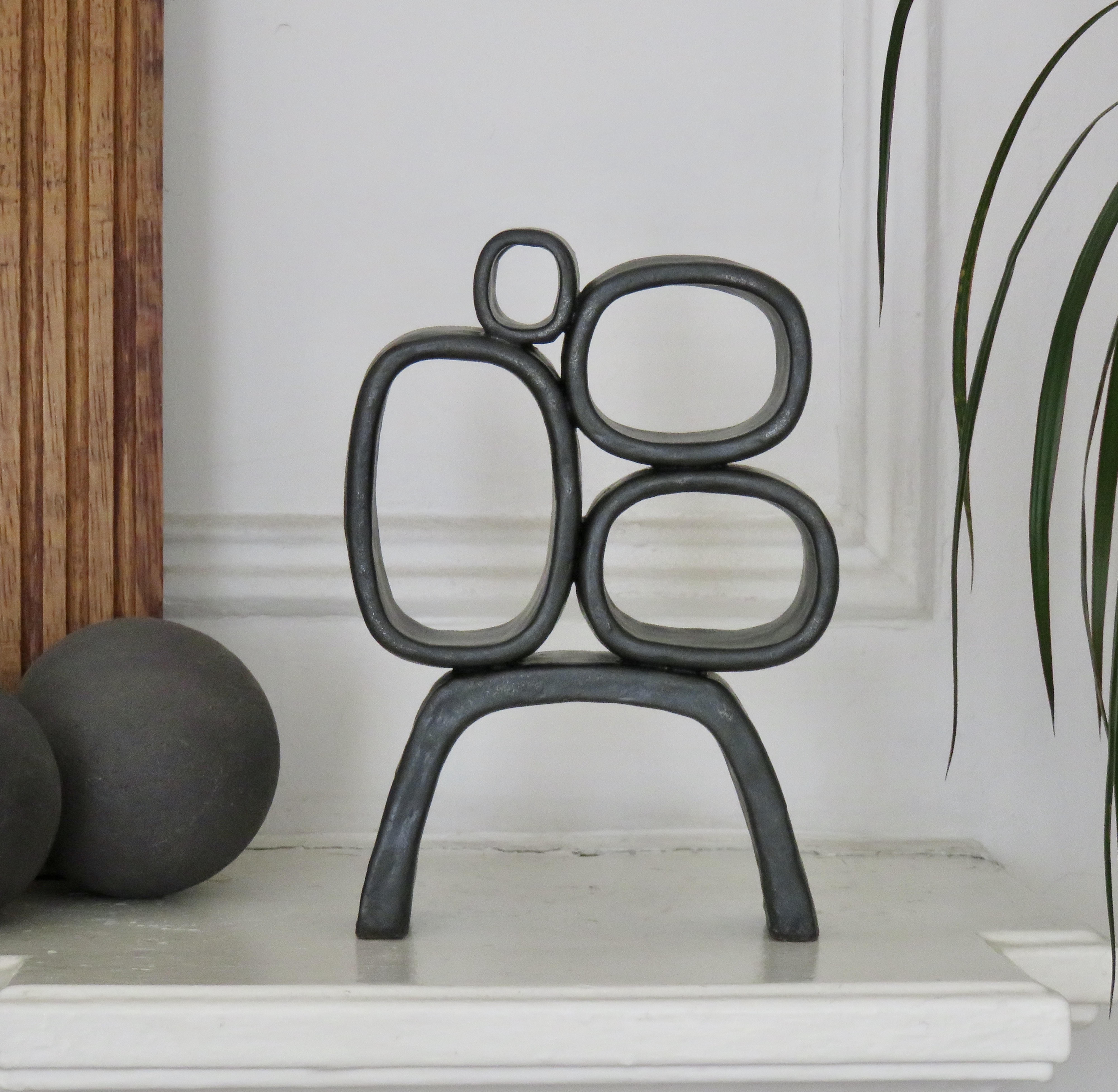 Metallic Black Hand-Built Ceramic Sculpture with Hollow Rings on Angled Legs 11