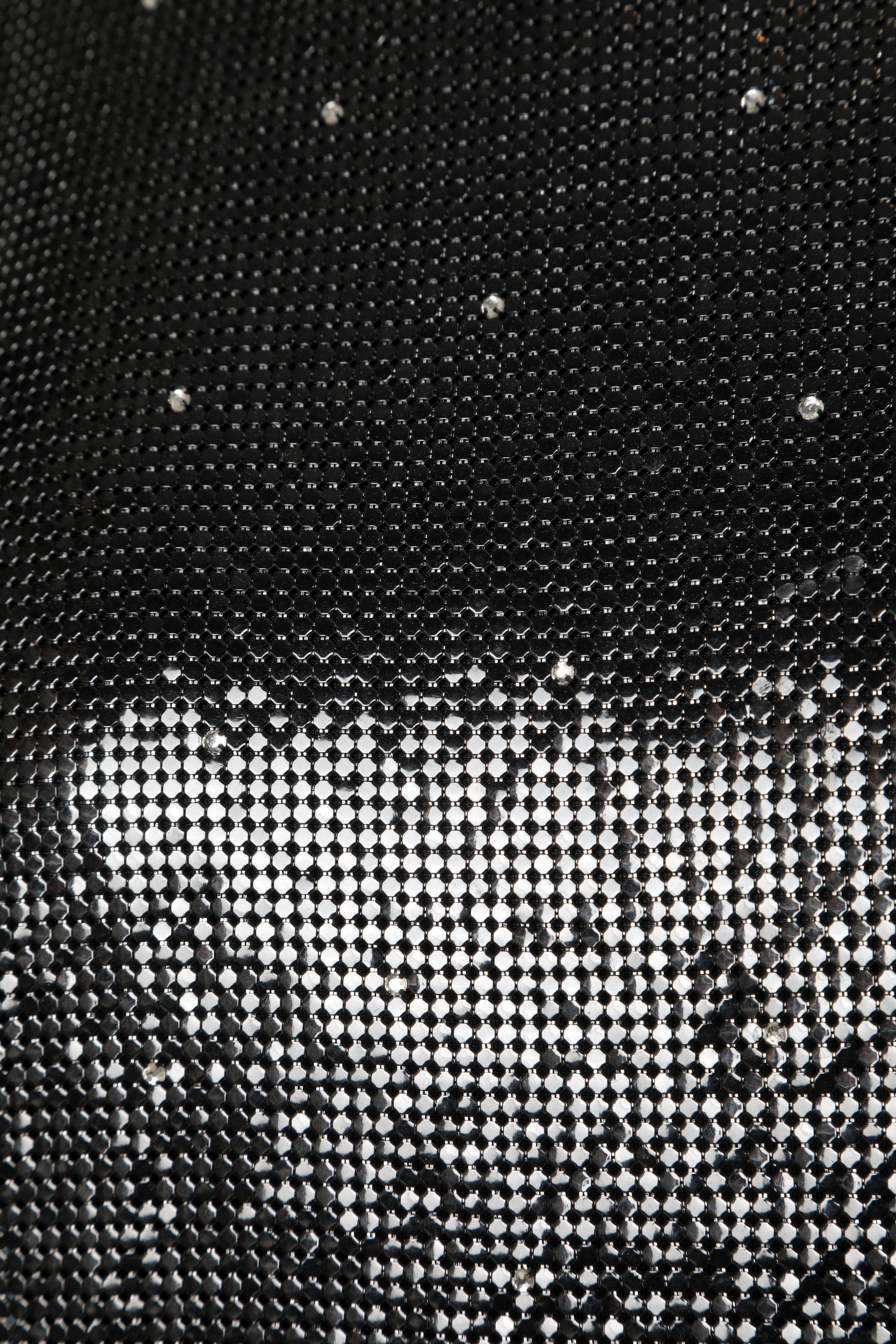 Dress in black metallic mesh and rhinestones. Back zip. Gianni Versace Sera label.
Size: 38/40 French
