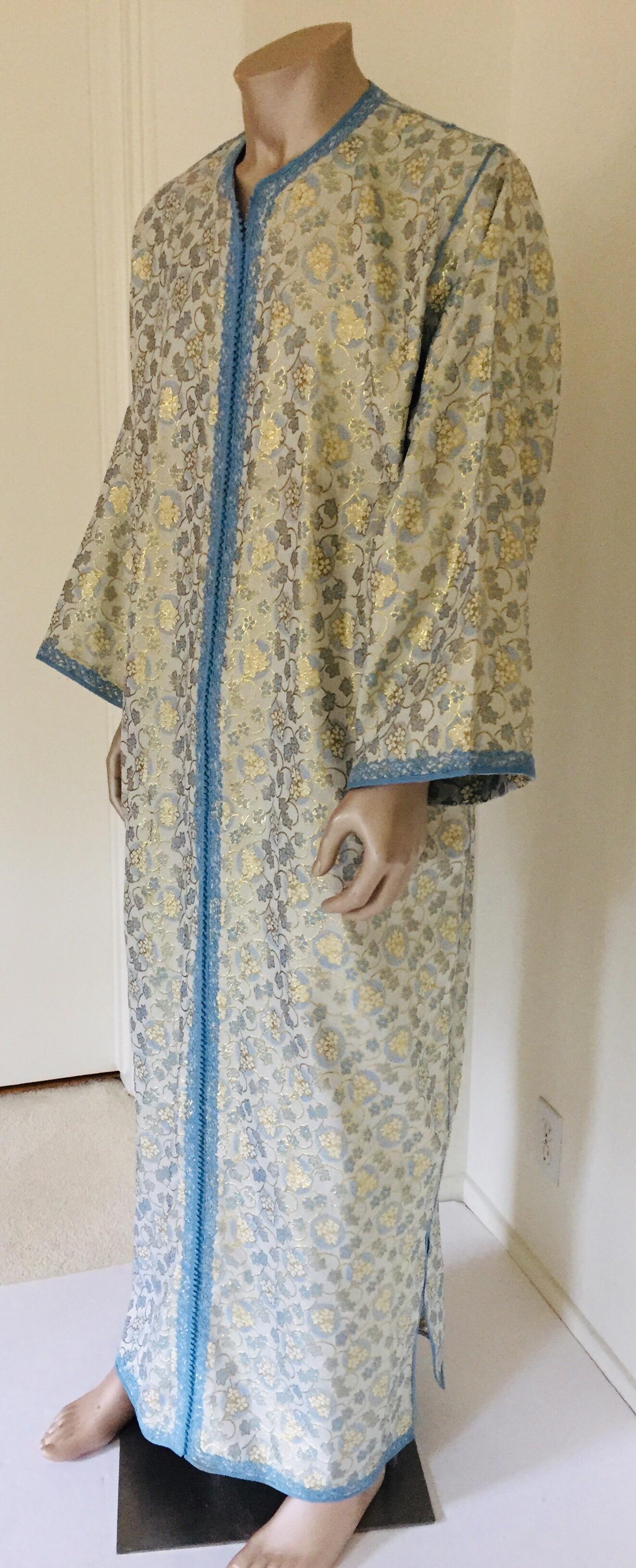 Metallic blue and silver brocade dress kaftan with silver and blue trim.
Handmade long maxi dress caftan from North Africa, Morocco.
Vintage exotic 1970s silver metallic brocade caftan robe.
The luminous metallic silver and gold maxi dress caftan
