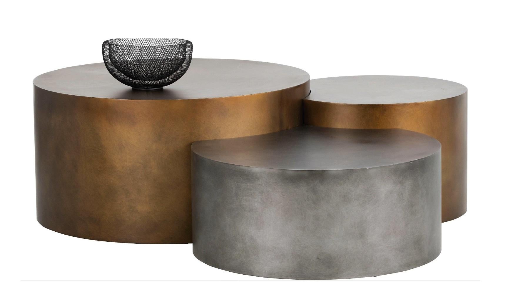 Available as a set of three contemporary coffee tables - this trio is crafted from steel in varying brass and nickel finishes. 

An elegant and playful design that can easily be integrated in a large variety of interiors, the tables come in three