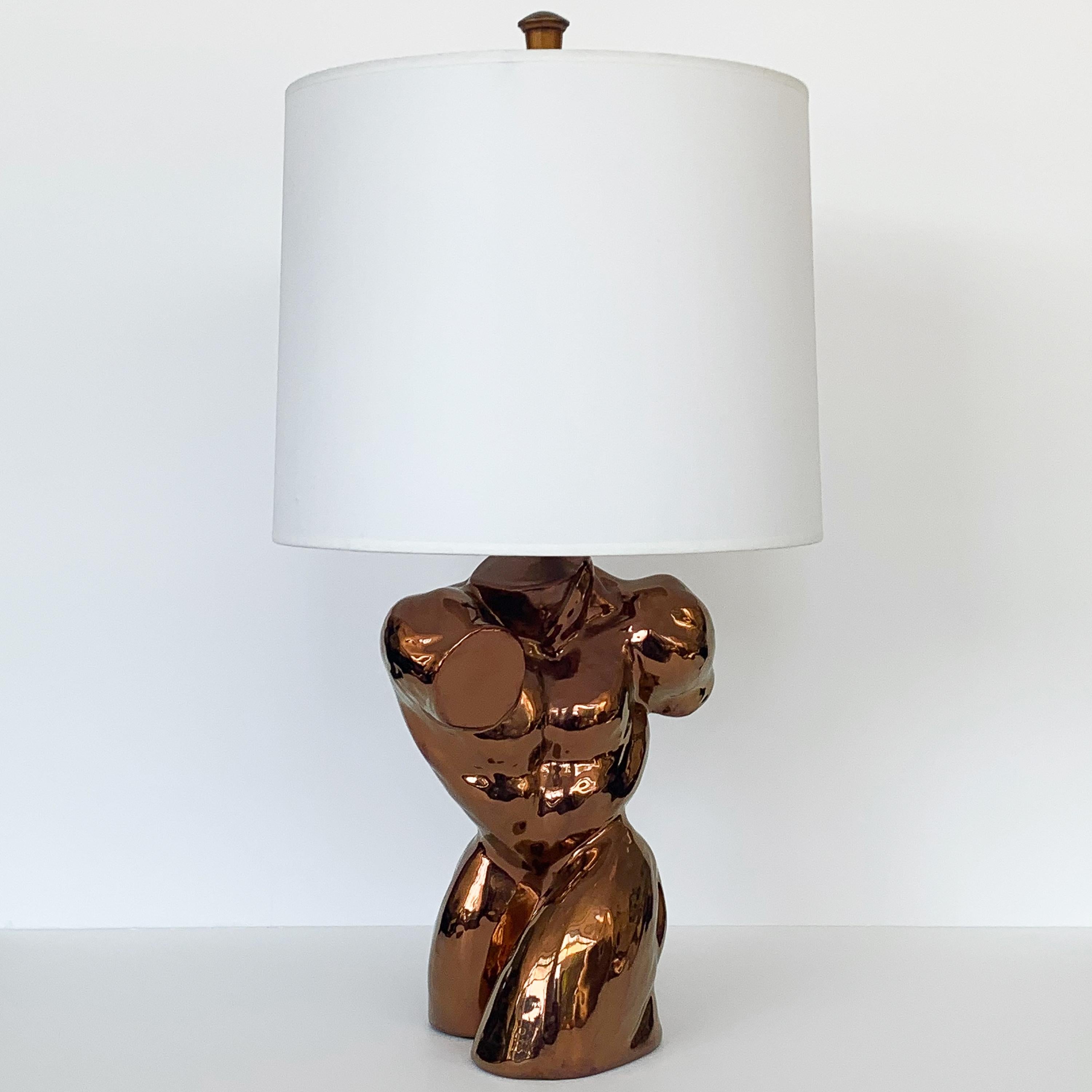 Nude male torso table lamp in metallic copper glaze over ceramic, circa 1970s. Incredible and striking sculptural lamp! Takes one standard base light bulb. Base 14
