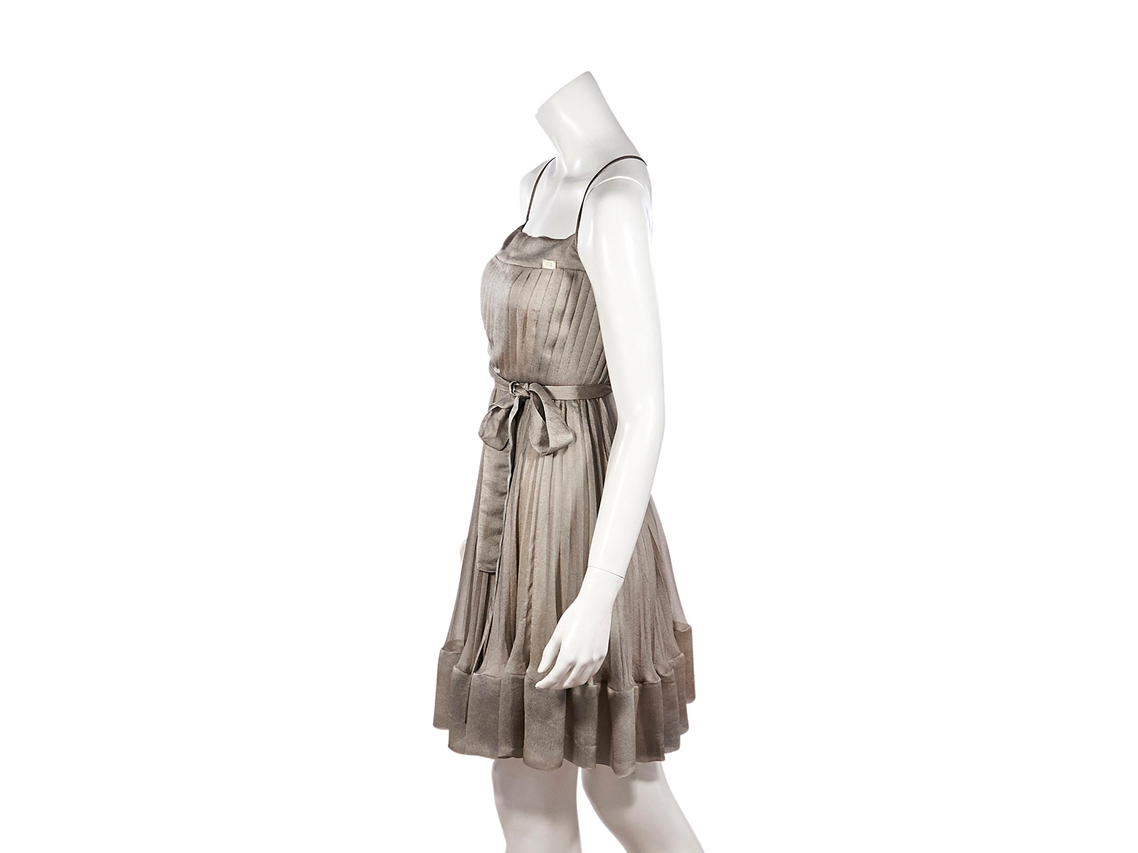 Product details:  Metallic silver pleated dress by Chanel.  From the AW 2001 collection.  Sleeveless.  Self-tie belted waist.  Concealed button and zip back closure.  Label size FR 34.  32