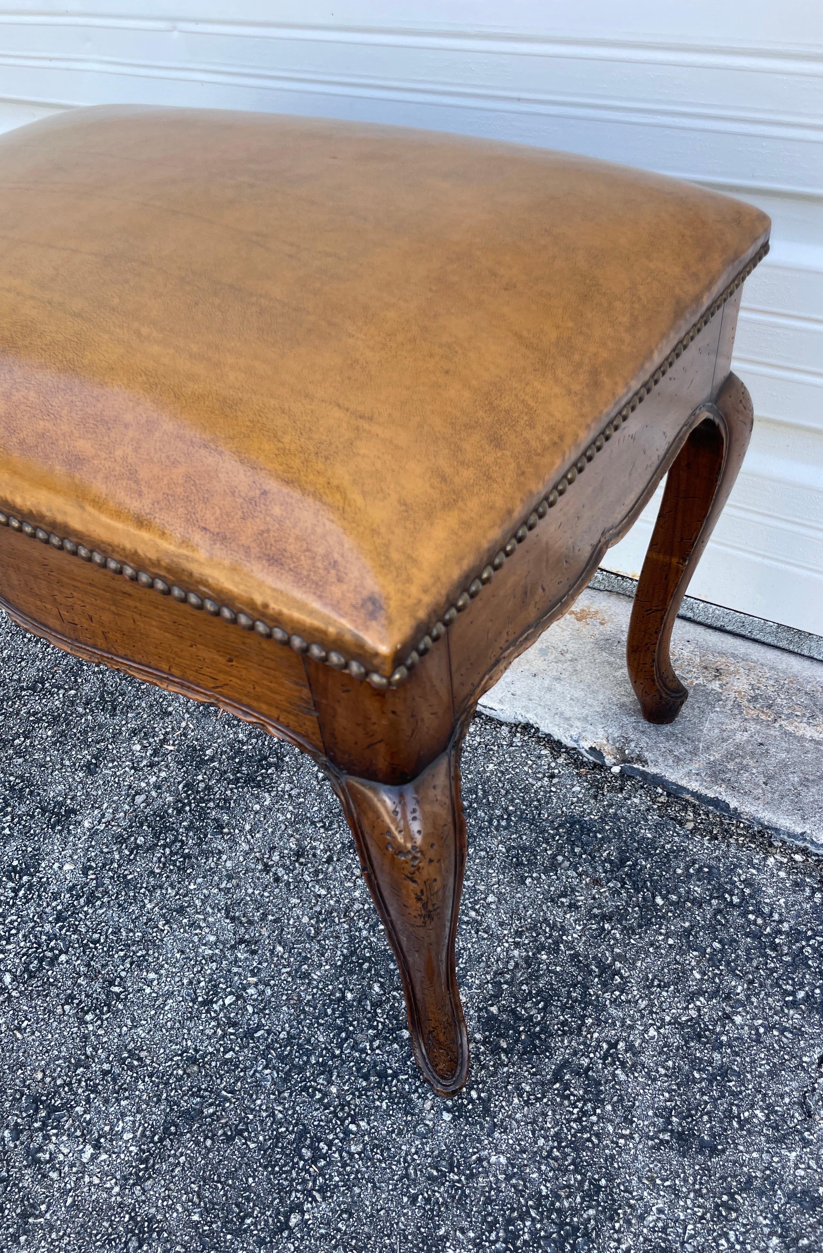 Very unique and unusual metamorphic bench / library steps with cabriole legs.. It appears to be a bench covered in tobacco brown leather with nail heads. The top lifts and folds down to reveal a mechanical set of steps forming a ladder.