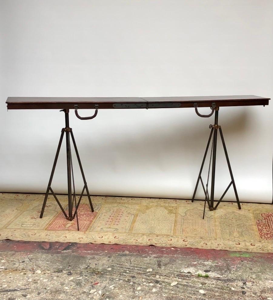 An Extraordinary Metamorphic Telescopic Mahogany Campaign field table / equestrian table made in the 19th century. This unusual Campaign Field Table is concealed in a solid mahogany folding box that has steel hinges and leather wrapped steel