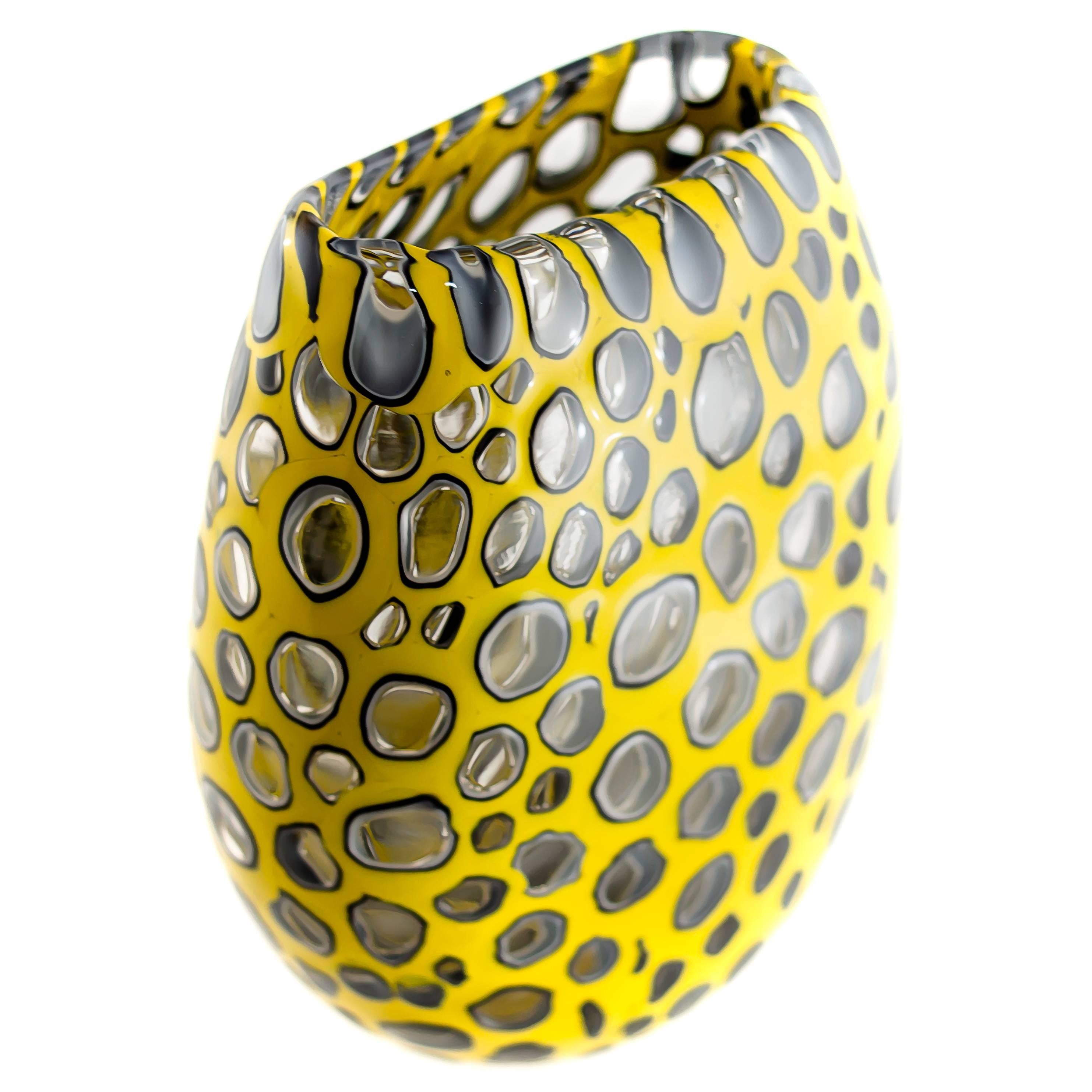 Meteor Murrine cheetah U-vase
Originally inspired by cellular patterning, these works of art have morphed into forms with an intergalactic quality. Murrine made of overlaying colors on a clear core are created and then fused together in a carefully