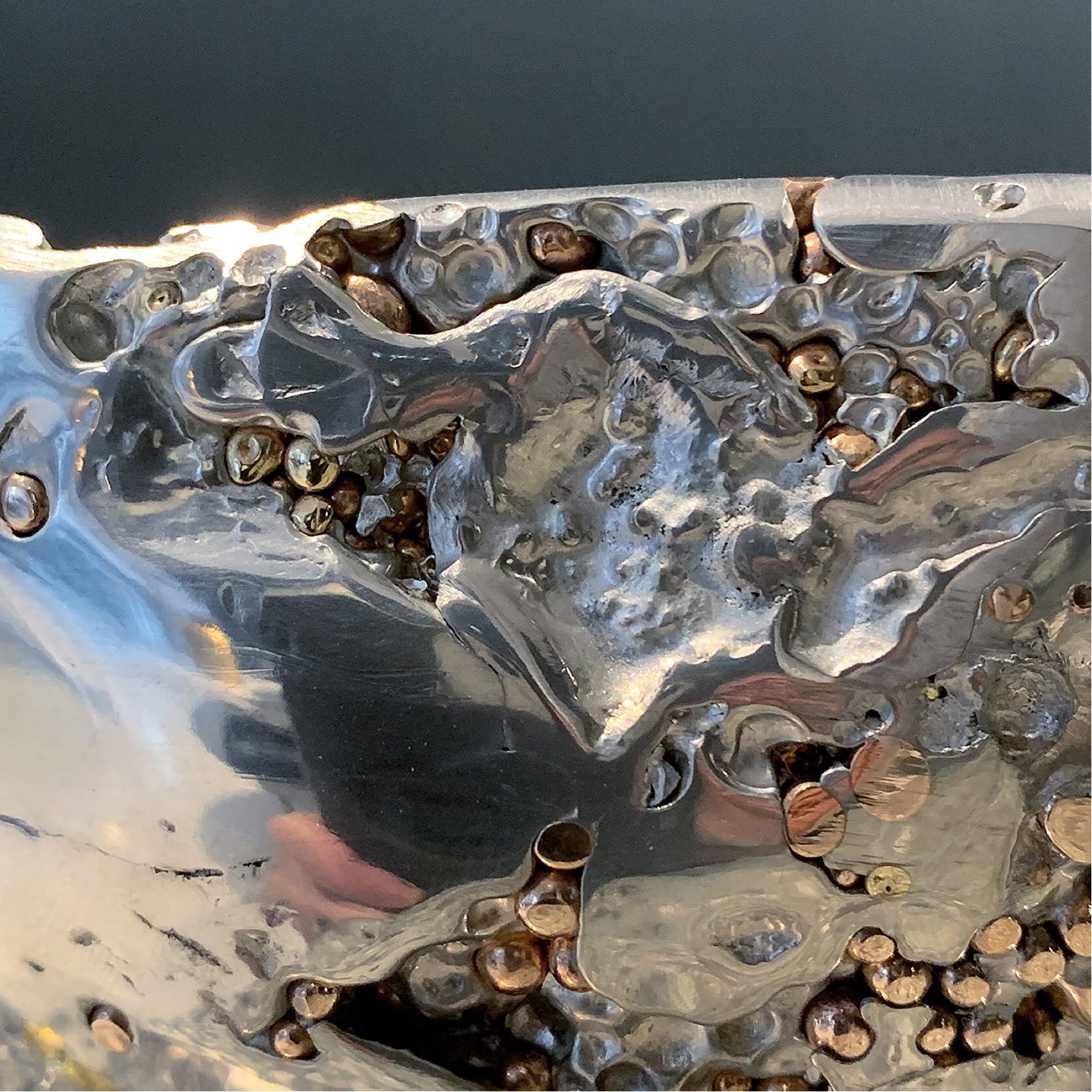 In stock. This contemporary decorative bowl is a unique piece, created by Xavier Lavergne and made of melted pewter with bronze and brass grains. It seems like a Meteorite discovered in Italy. Handmade in France and sold with its “Certificate of