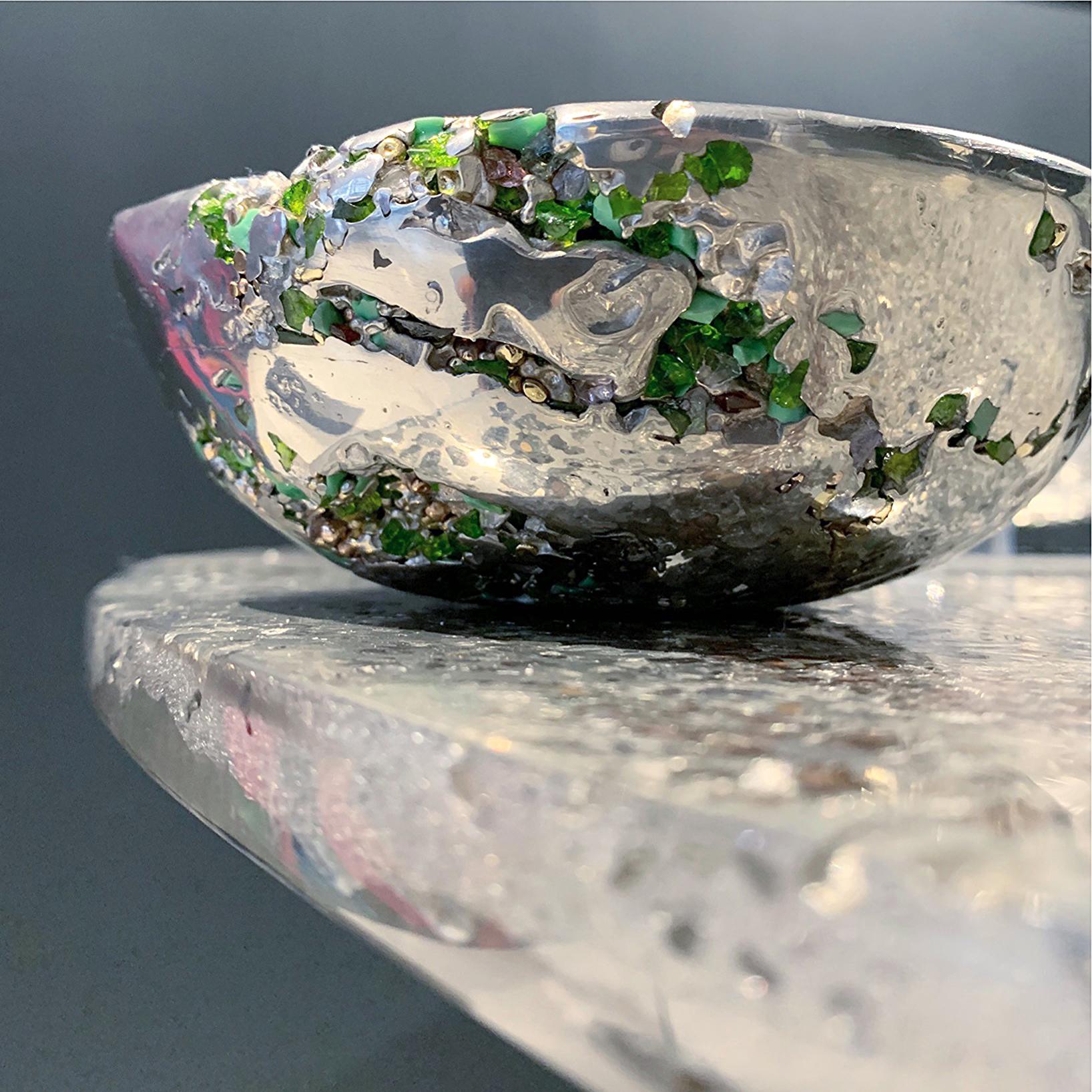 In stock. This contemporary decorative bowl is a unique piece, created by Xavier Lavergne and made of melted pewter with Venice Murano glass. It seems like a Meteorite discovered in Irland. Handmade in France and sold with its “Certificate of