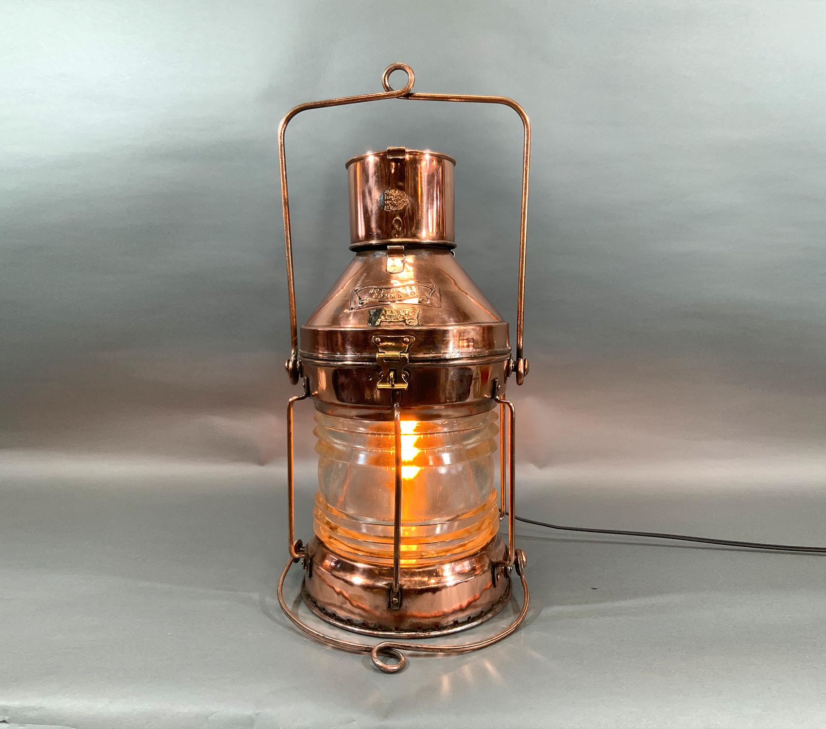 Copper and brass ships “not under command” lantern with clear Fresnel glass lens. Fitted with brass badges. Copper hoisting handle. Polished and lacquered. Wired for home use. Remnants of a makers badge from R.C. Murray.

Weight: 20 LBS
Overall