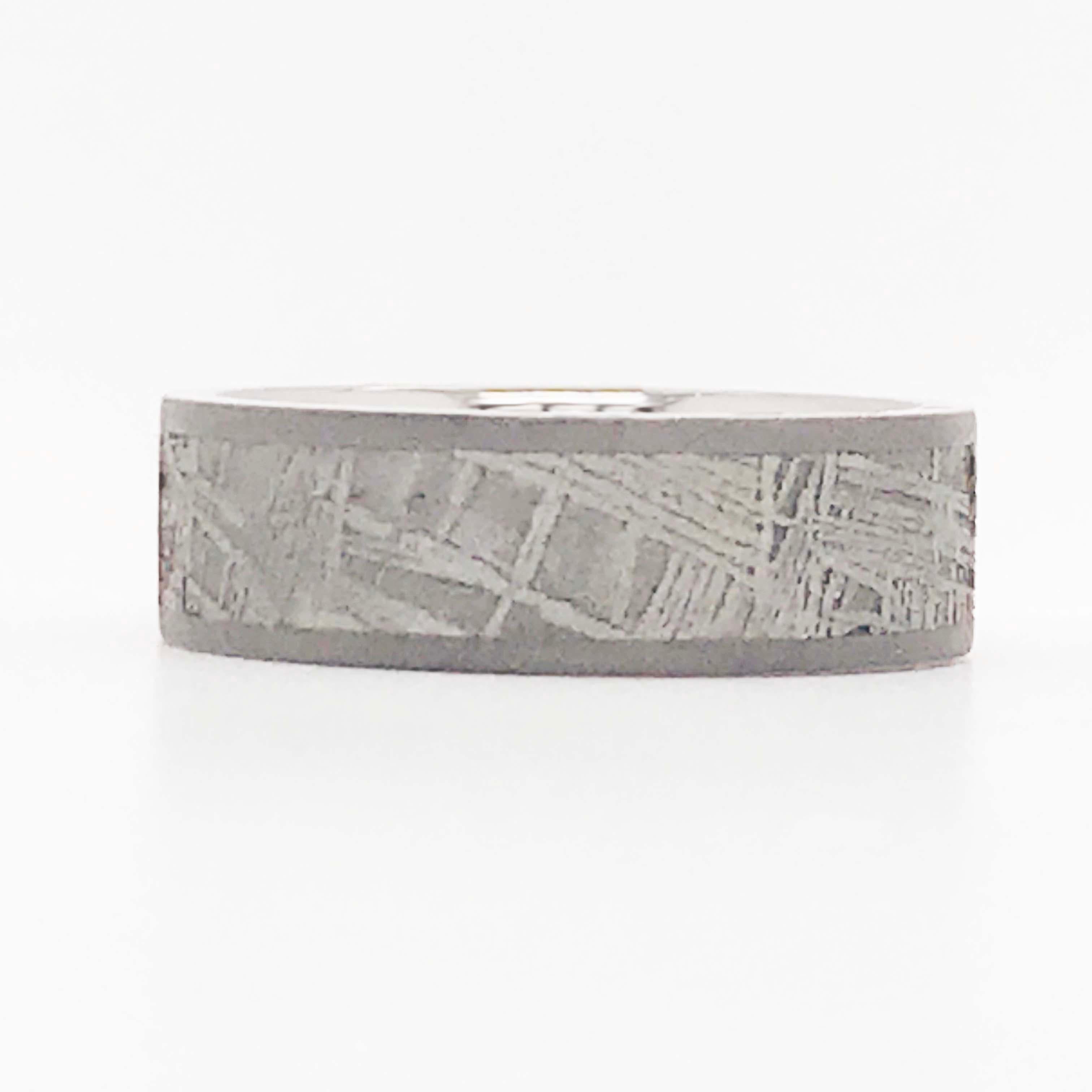 This custom titanium meteorite band ring is a durable, industrial, and unique design! The band is a flat band style titanium band with an inlay of a meteorite!  The band is 7 mm wide and made with a 5mm wide inlay of a genuine meteorite! The