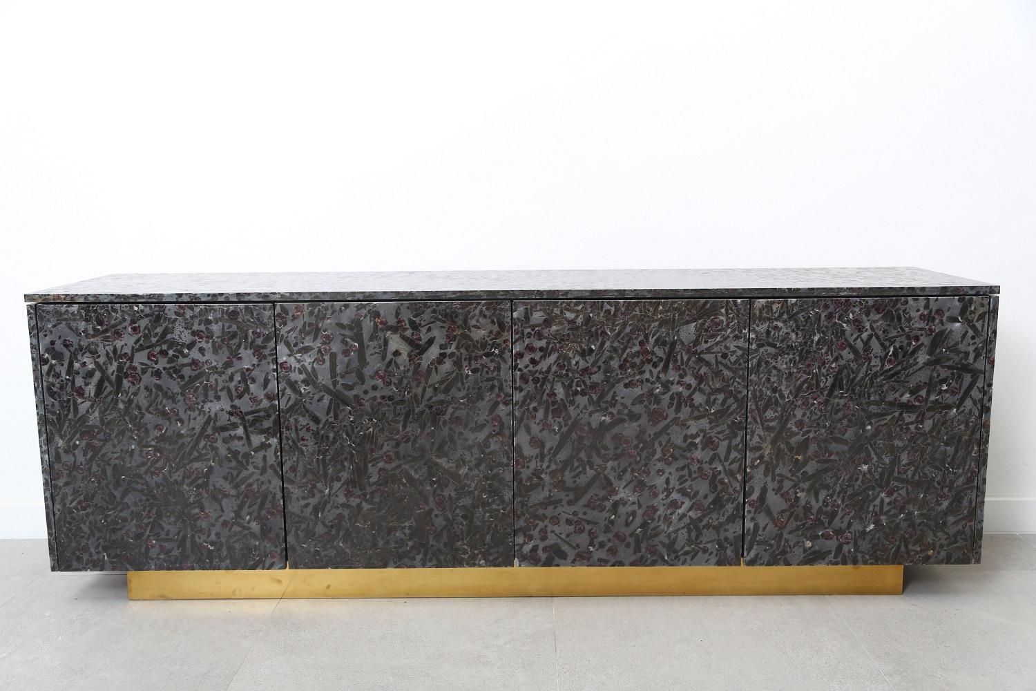Four-door console made of Meteurus granite. The Meteurus granite is a stunning exotic granite from Brazil. The background made of silver black crystals grains it’s embellished by black biotite. What makes this granite extraordinary beautiful is the