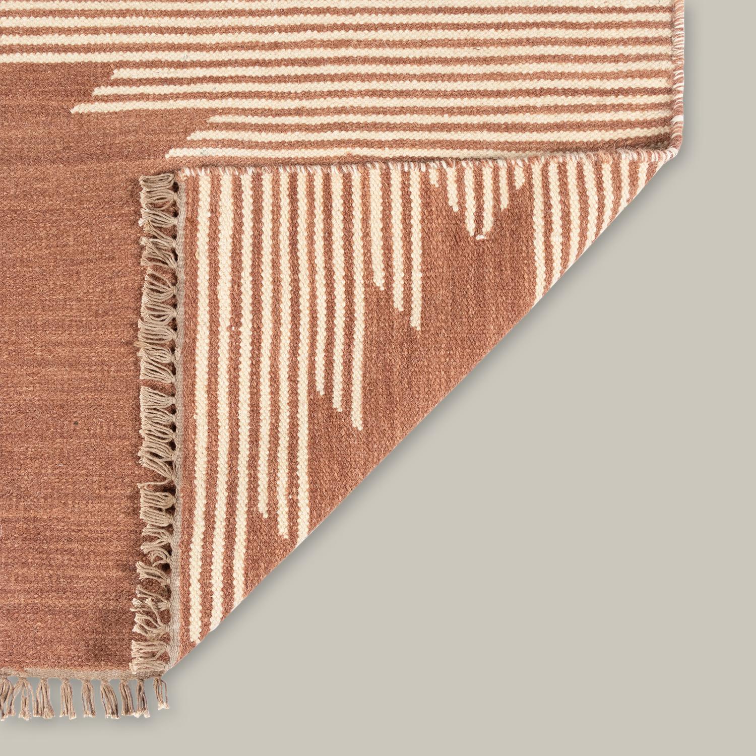 Imbued with a sense of movement, the Metlili Collection nods to the glorious imperfection found in all handcrafted textiles. Handwoven out of wool and finished with an antique wash that mutes colors and ages the material, each pattern has a vintage