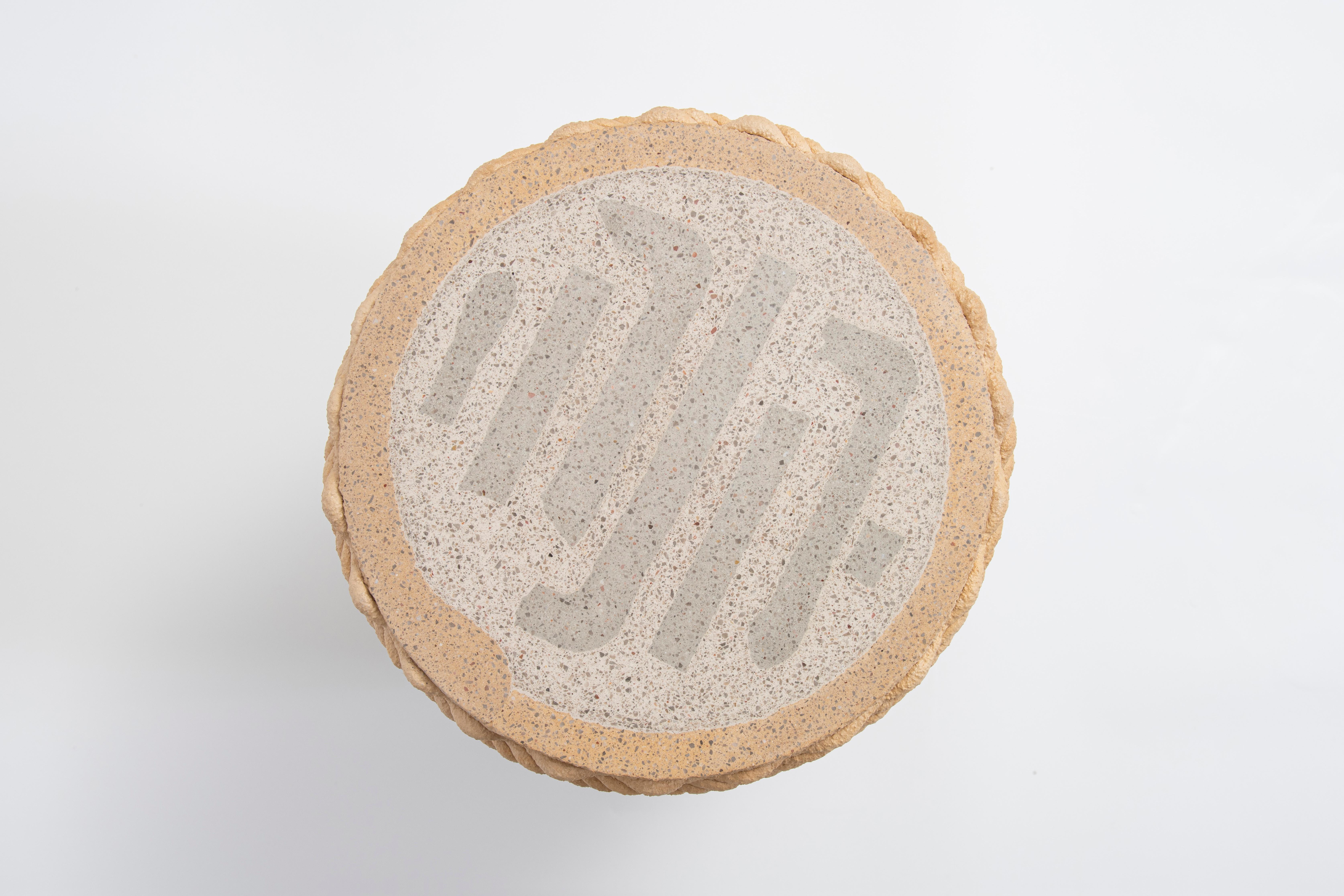 The Metric Stool and Table by Philipp Aduatz, produced in collaboration with Austrian manufacturer incremental3d, demonstrates the fusion of sculptural design with advanced 3D concrete printing technology using recycled material.
The piece functions