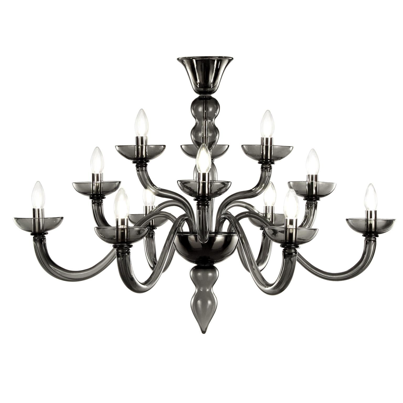 Metropole chandelier with 12 lights staggered in 3 levels. Artistic blown dark grey Murano glass.
Metropole is a modern Murano glass chandelier characterised by an essential design and perfectly balanced shapes. This classic chandelier has been