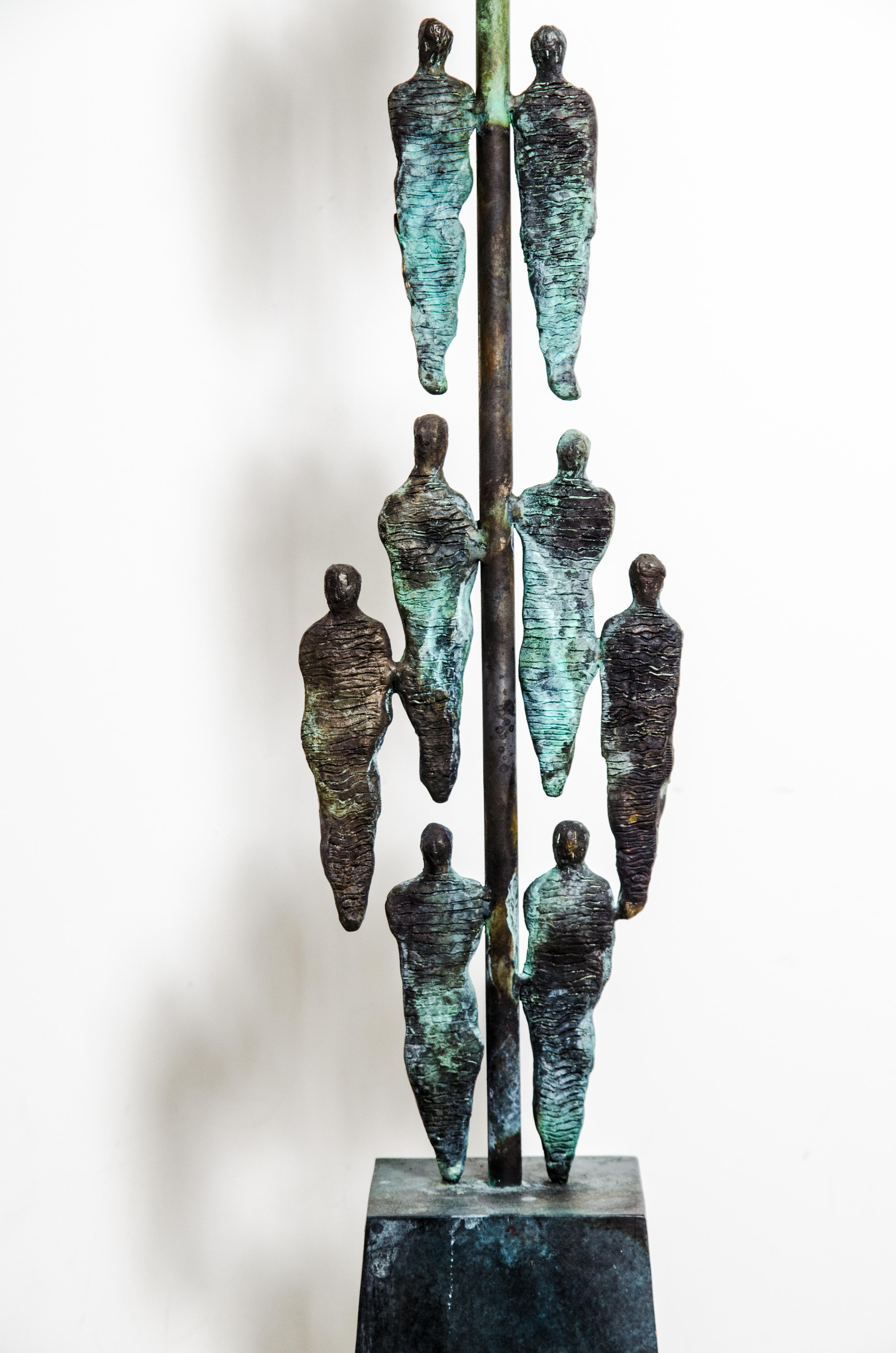 'Metropolis' bronze sculptural floor lamp is hand crafted by Studio Rinat Design and molded and cast in bronze in the lost wax process. The floor lamp consists multiple figures of abstract human forms. Each figure is individually molded, cast in