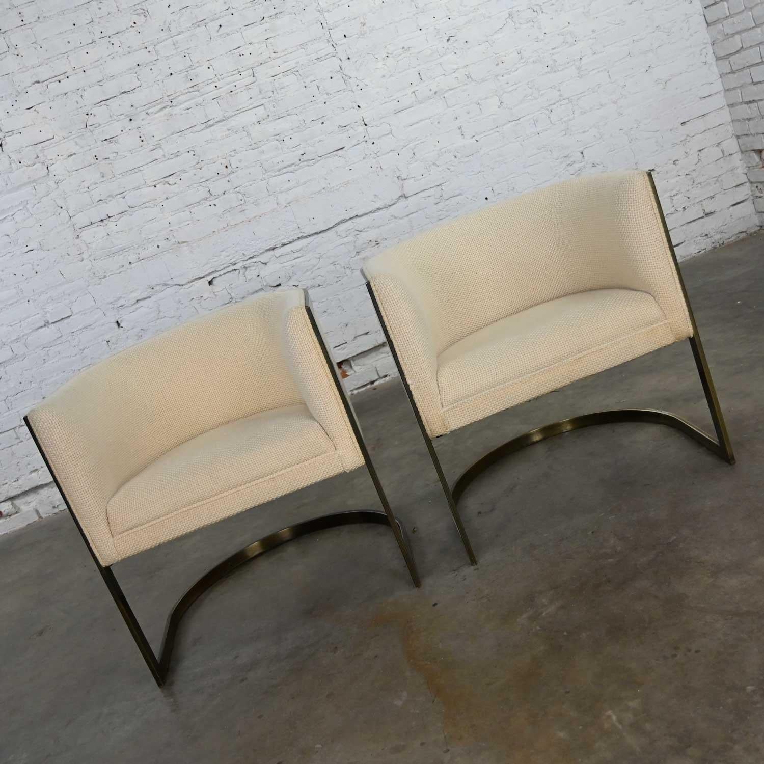 Awesome modern white tub chairs by Jules Heumann for Metropolitan Furniture Company. They are comprised of antiqued brass plate frames and wear their original white hopsacking fabric. Beautiful condition, keeping in mind that these are vintage and