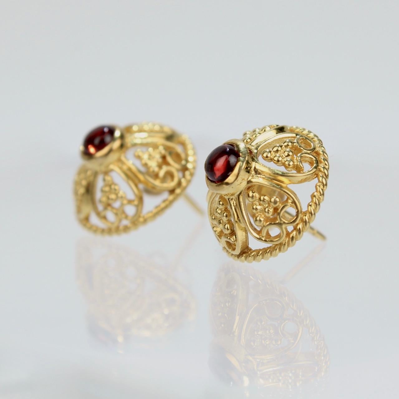 A wonderful pair of Renaissance style earrings.

With bezel-set oval garnet cabochons in 14K gold with filigree decoration.

Originally sold in the MMA gift store, as one of their top quality, period-inspired pieces. 

Marked 585/14k for gold