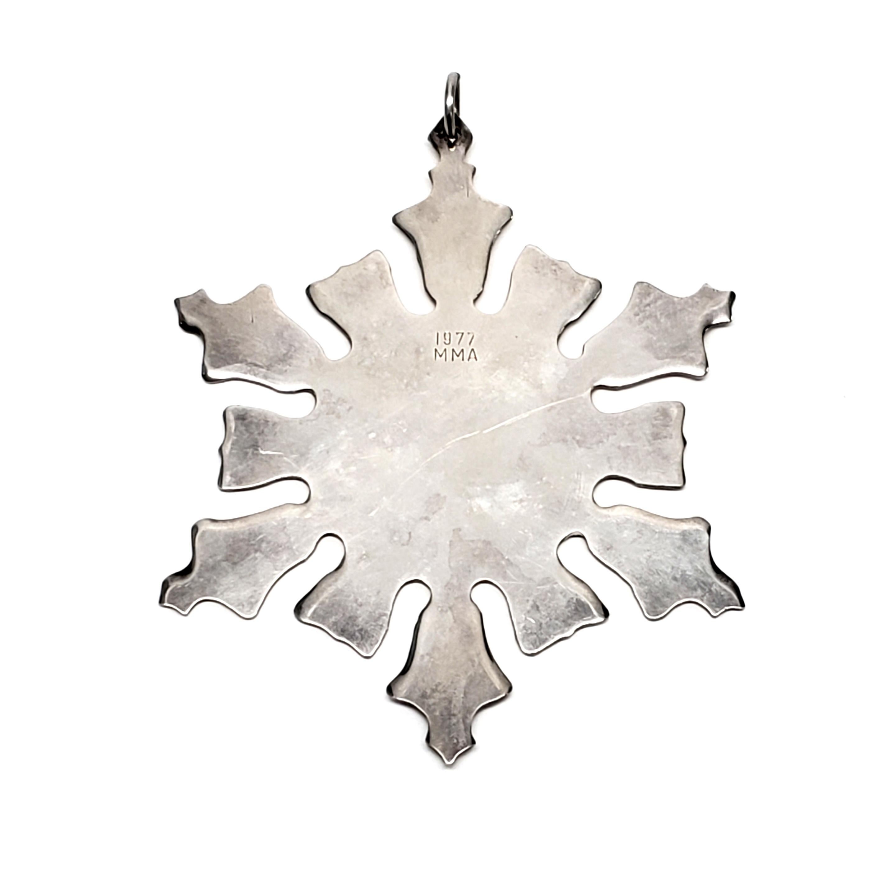 Vintage Snowflake Ornament from the Metropolitan Museum of Art from 1977.

This classic snowflake design ornament is part of the Met's snowflake ornament collection, which started in 1971.

Measures 3 3/8