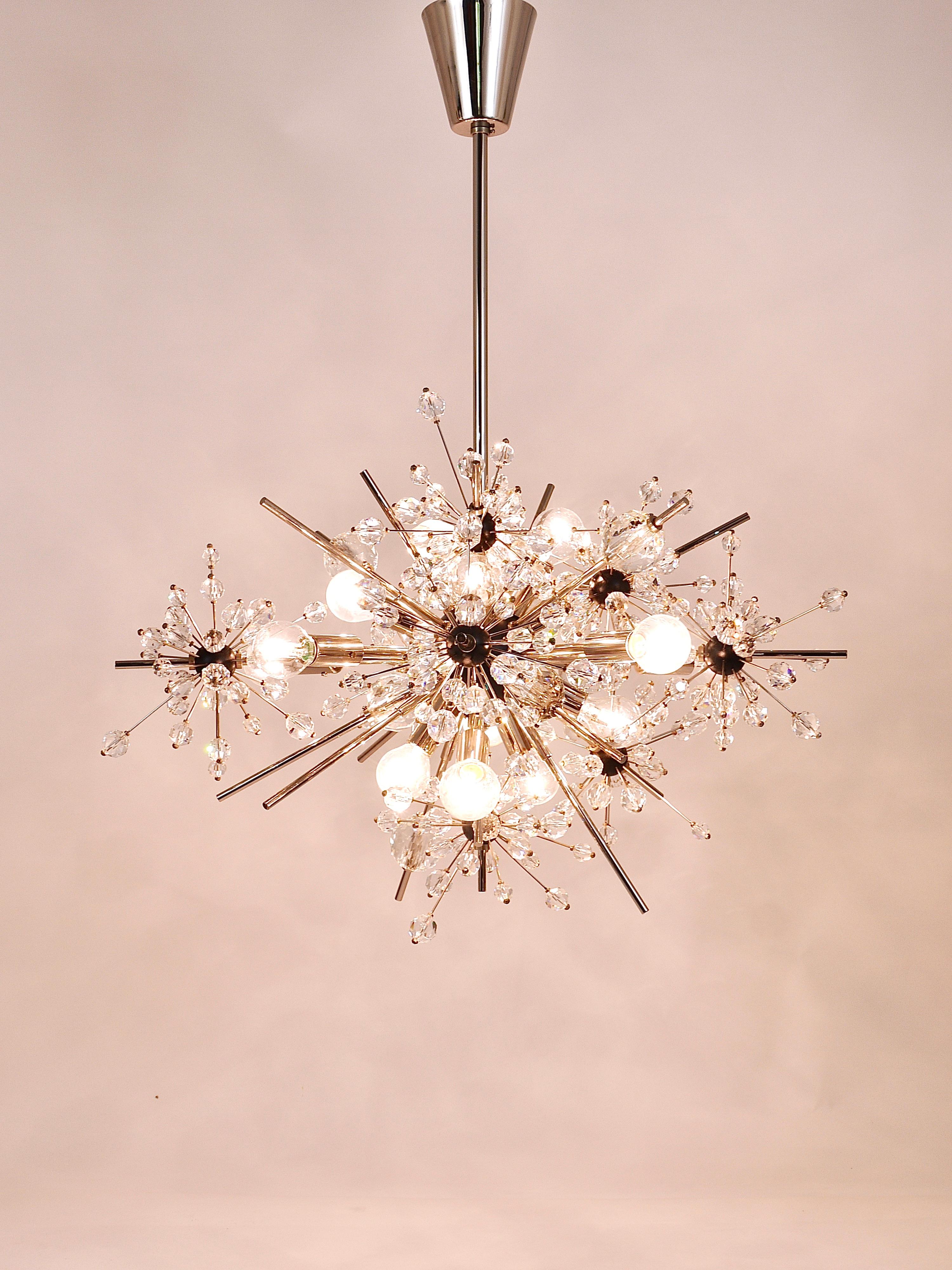 An iconic Mid-Century Sputnik starburst Met chandelier, designed by Hans Harald Rath in the 1966, executed by J. & L. Lobmeyr, Austria. Made of nickel-plated brass, Swarovski hand-cut crystals and a black center sphere. The chandelier has 13