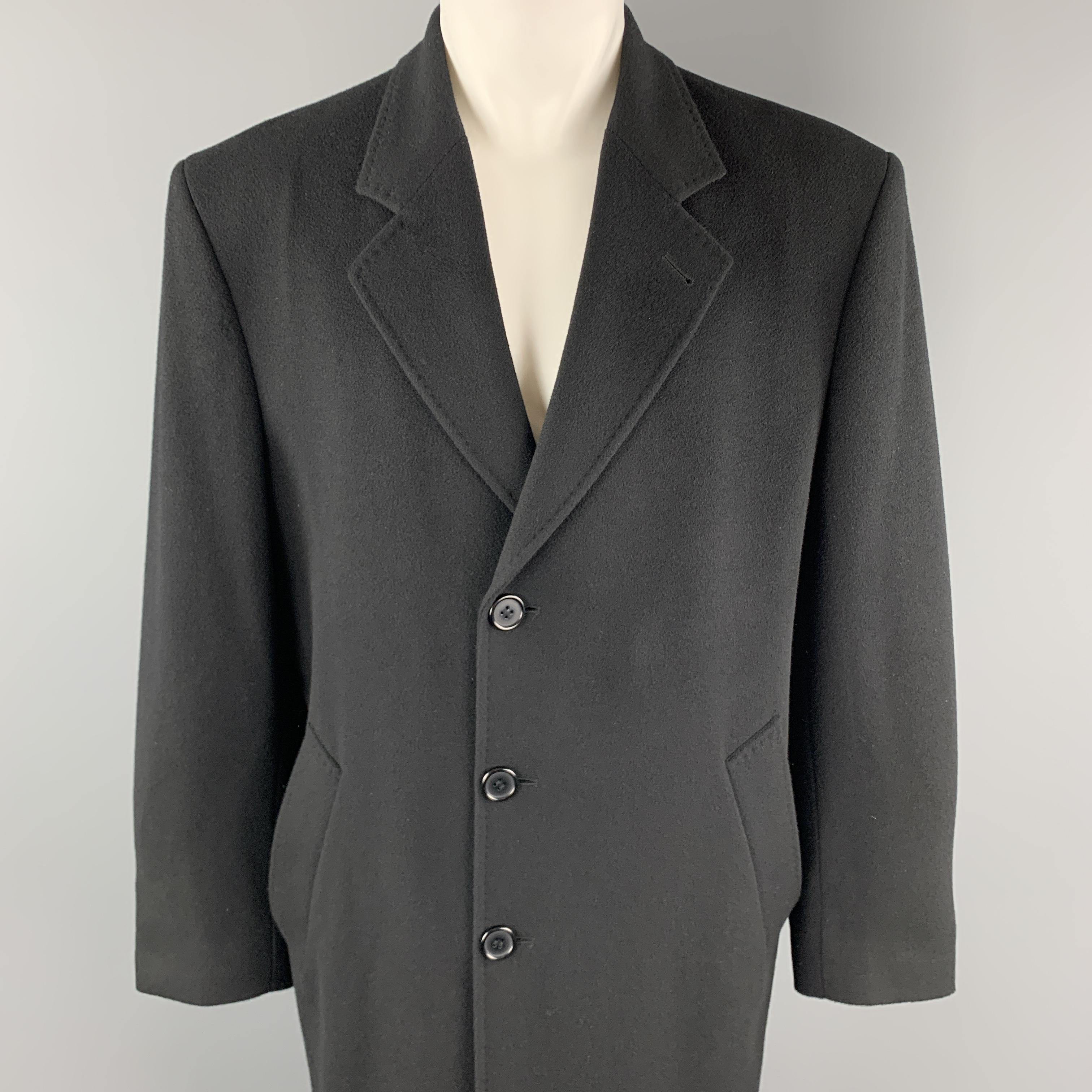 METROPOLITANVIEW over coat comes in black cashmere with a button front, slanted pockets, and top stitch notch lapel. Minor wear on liner. Broken button on sleeve cuff. As-is. Made in Italy.

Very Good Pre-Owned Condition.
Marked: IT