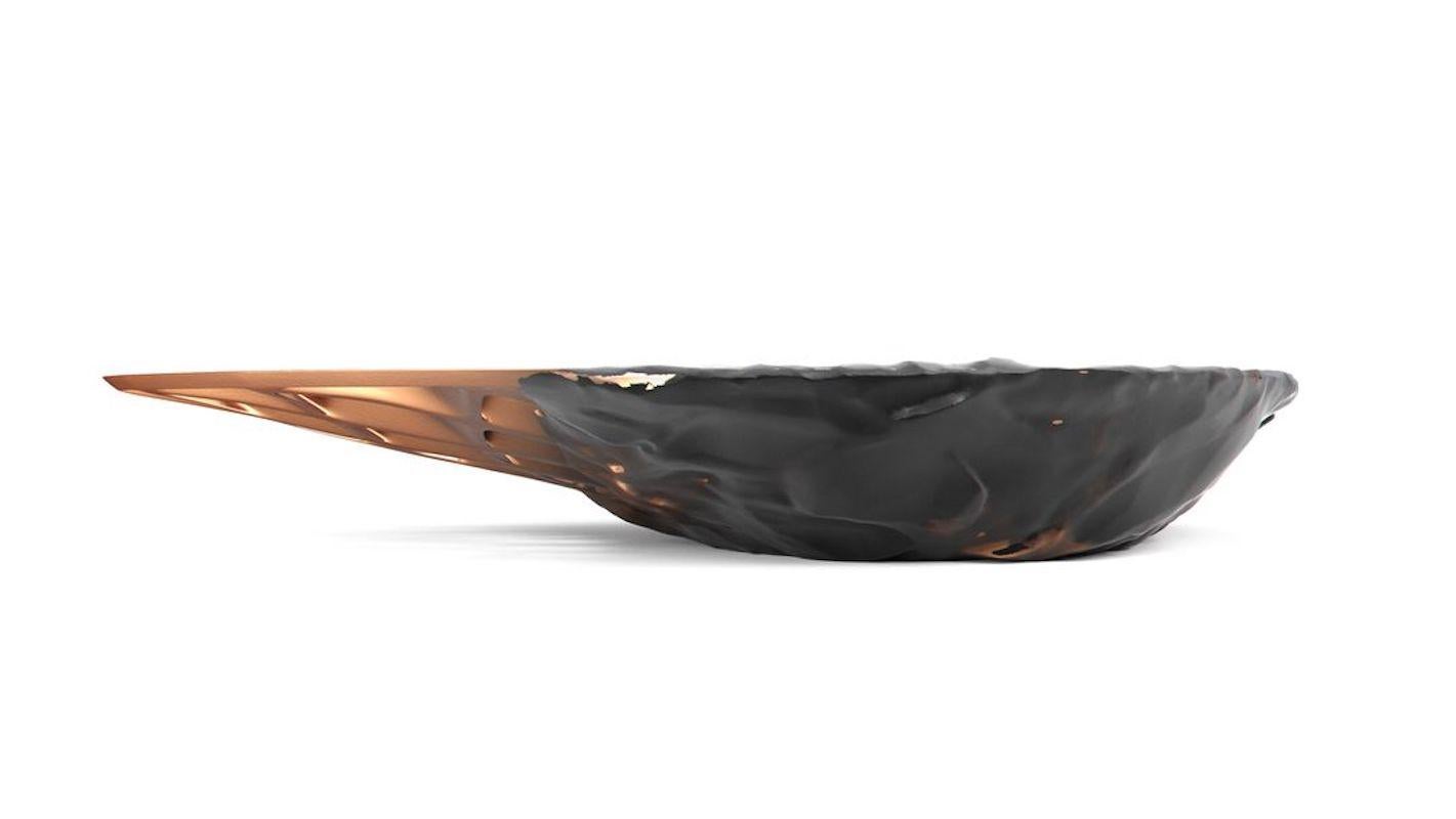 The Metsidian shelf and Metsidian side table are dynamic works that represent a moment in time – an eruption that melds two divergent materials together. The Prehistoric evolves into the futuristic as organic volcanic obsidian transforms into clean,