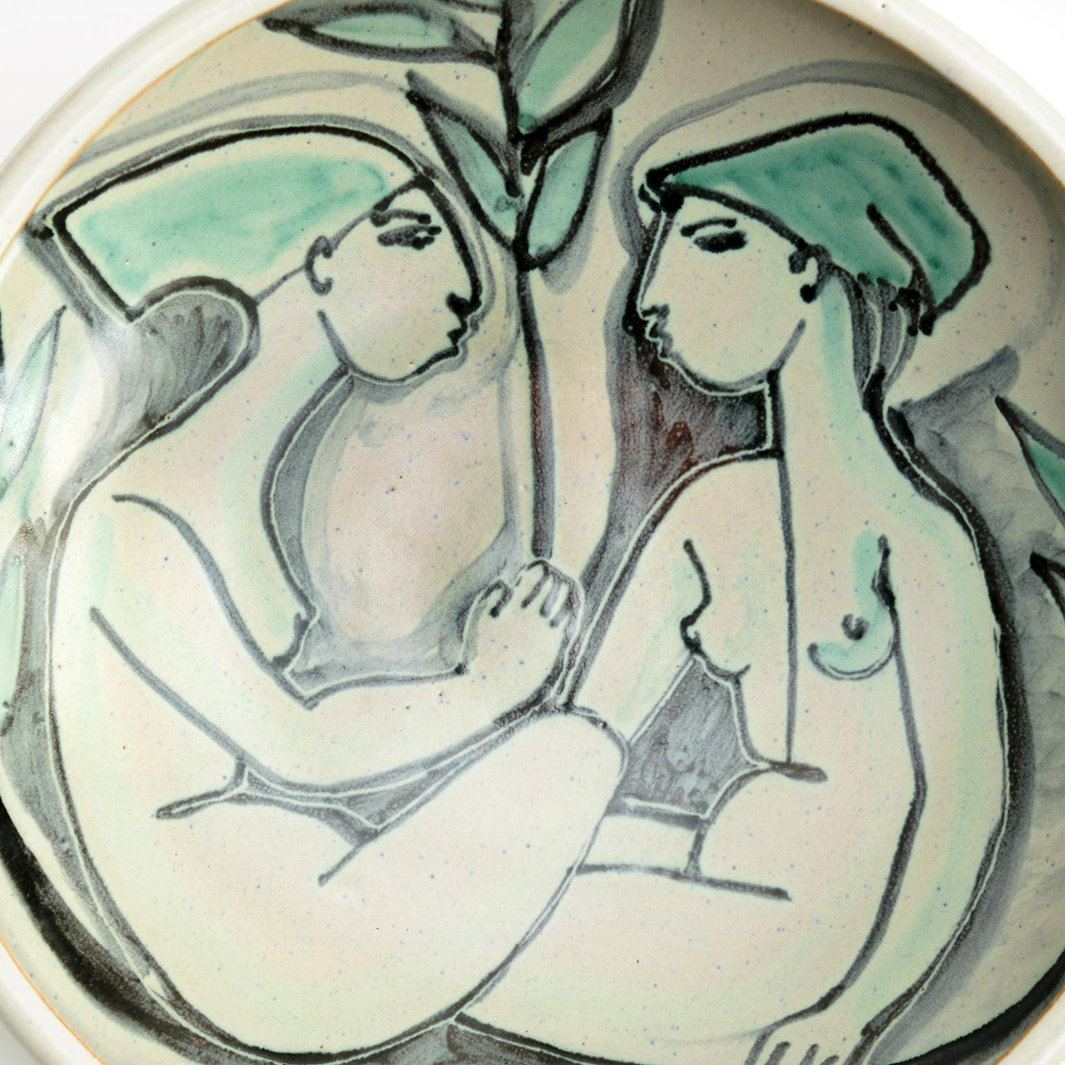 Danish Artist Mette Doller hand decorated ceramic bowl with two seated female figures with green hats. This bowl is signed by Doller on reverse along with Höganäs Keramik mark, Sweden, 1950’s.

Measures: Diameter: 11.25”, height: 3.25”.