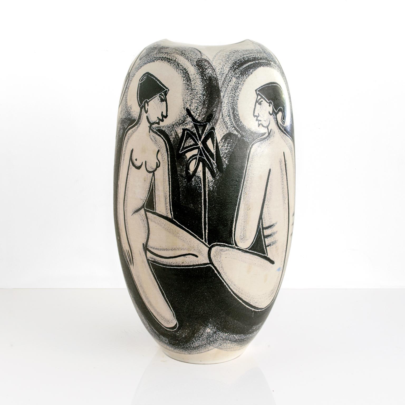 Scandinavian Modern, hand decorated ceramic vase by Danish artist Mette Doller on a form by Erik Ivarsson. Produced for the Swedish company Andersson & Johansson - Höganäs Ceramic, circa 1950's. The vase artistically depicts four figures possibly