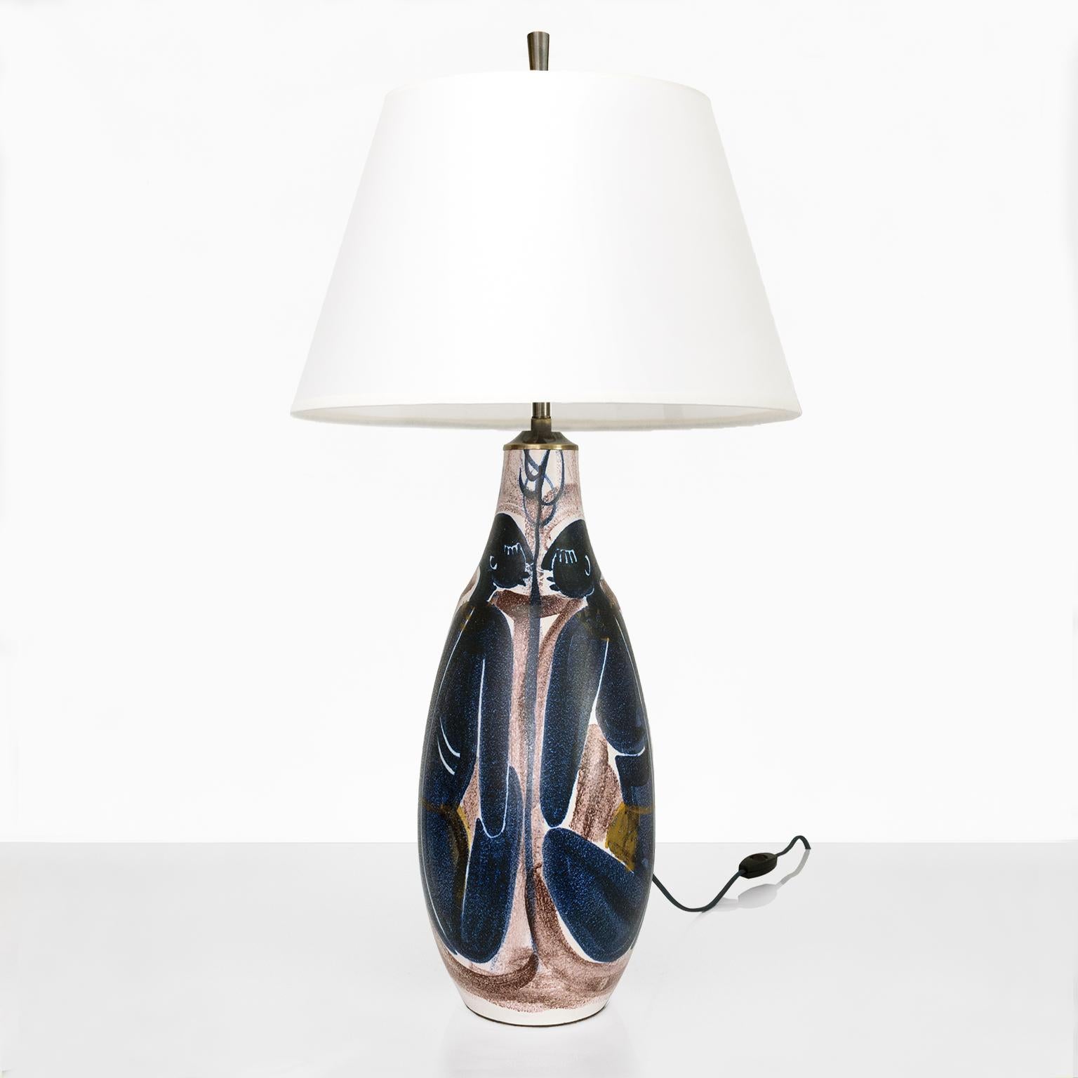 Large Mette Doller hand painted ceramic lamp with 4 seated women in dark blue against a maroon and white background. Newly fitted with custom patinated brass hardware which includes a double cluster of standard base sockets. Shade not included.