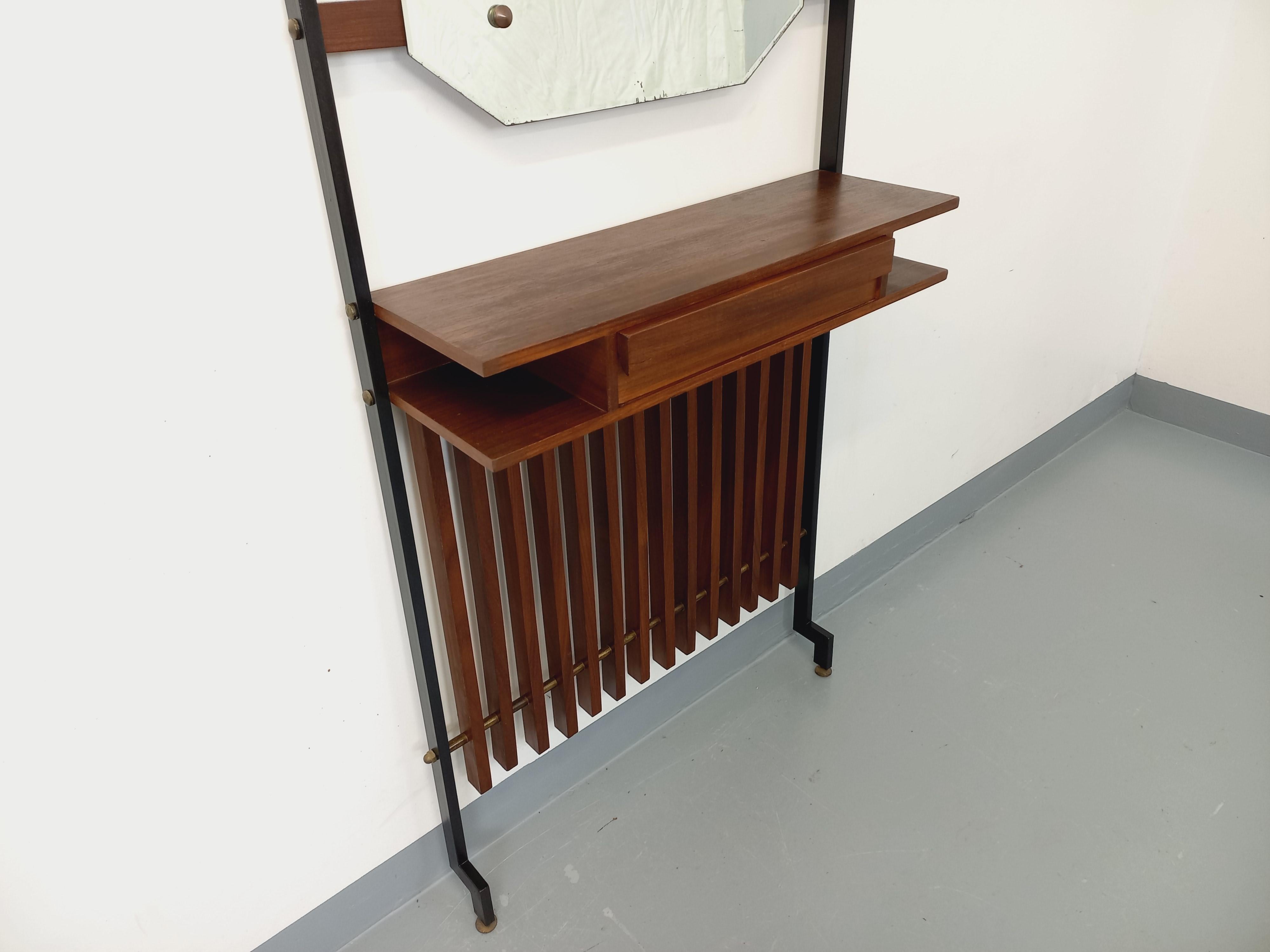 Meuble d'entrée vestiaire vintage des années 50 60, design italien, avec miroir, tablette et niches, tiroir, en teck et métal noir, très bon état général avec quelques signes du temps qui passe, notamment sur le miroir.
Réf 250 314
Hauteur : 175