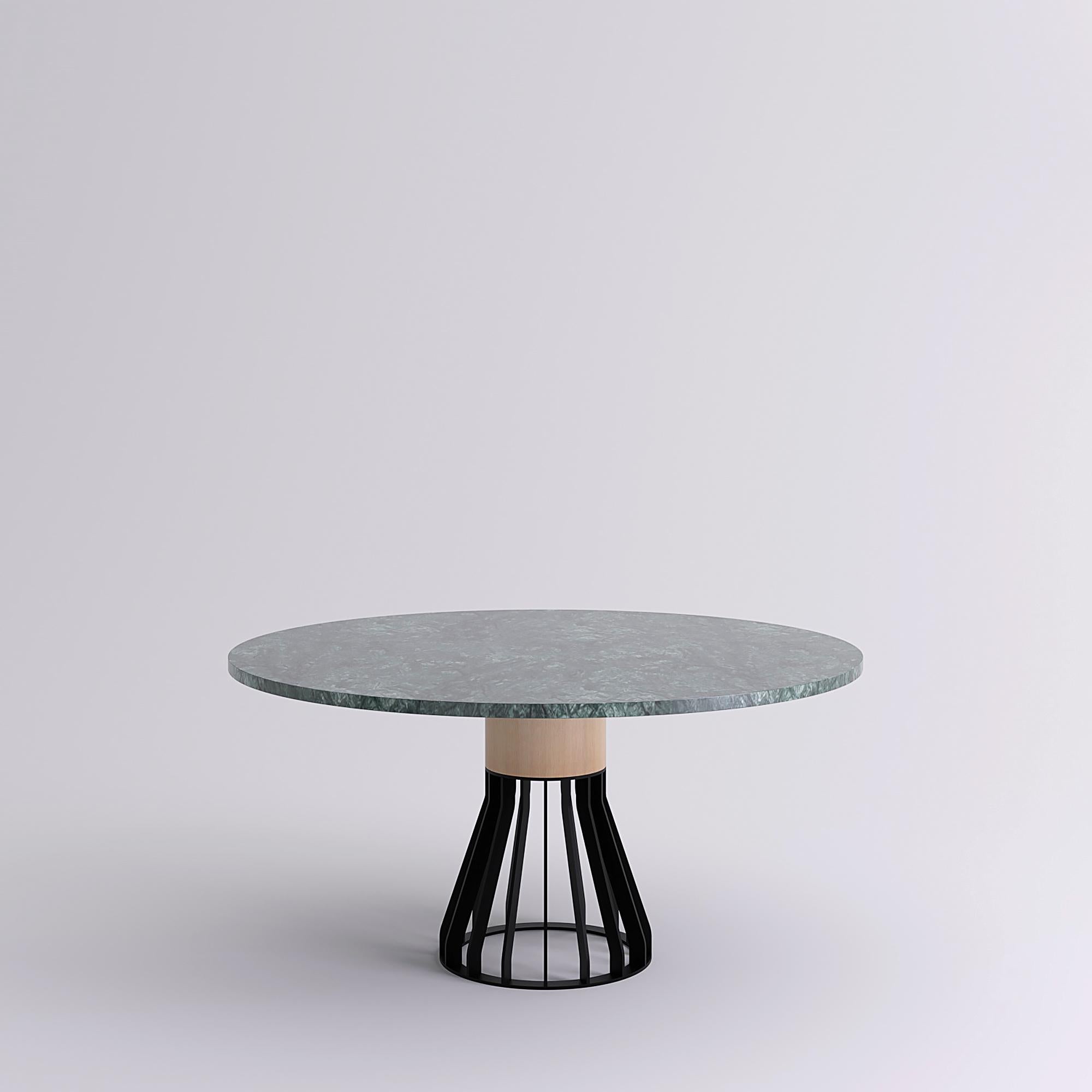 Mewoma is a family of tables with a sculptural presence. Measure: 150cm.
The table combines a laser cut metal base topped by a large wooden column supporting the marble top.
The three materials gave the table its name : metal (ME), wood (WO) and