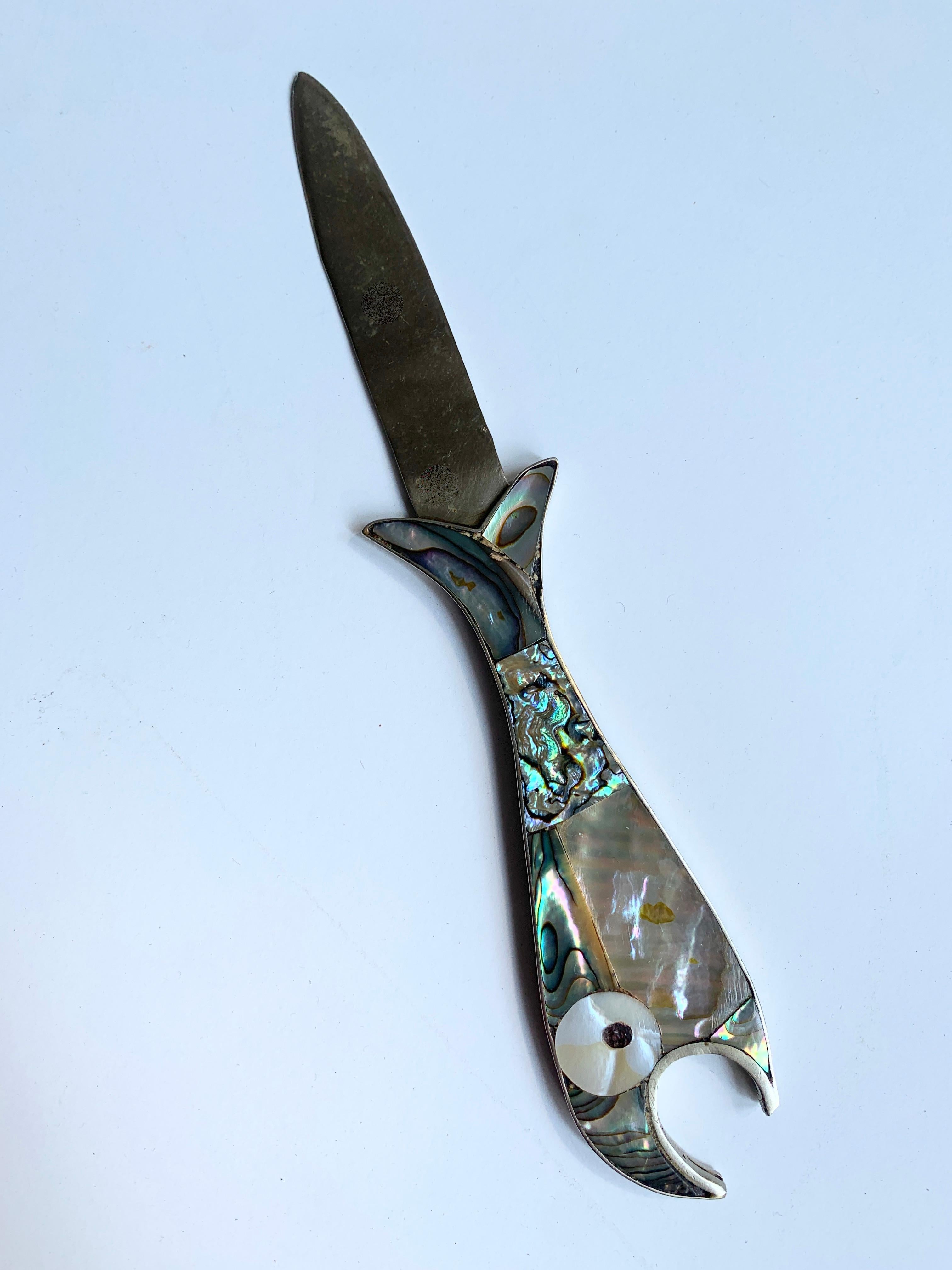 Abalone and silver fish bottle and letter opener - this says it all... Pop open a drink, open a letter and do it all in style! Handmade in Mexico of Alpaca Silver.

The letter opener portion is a random addition to the classic midcentury bottle