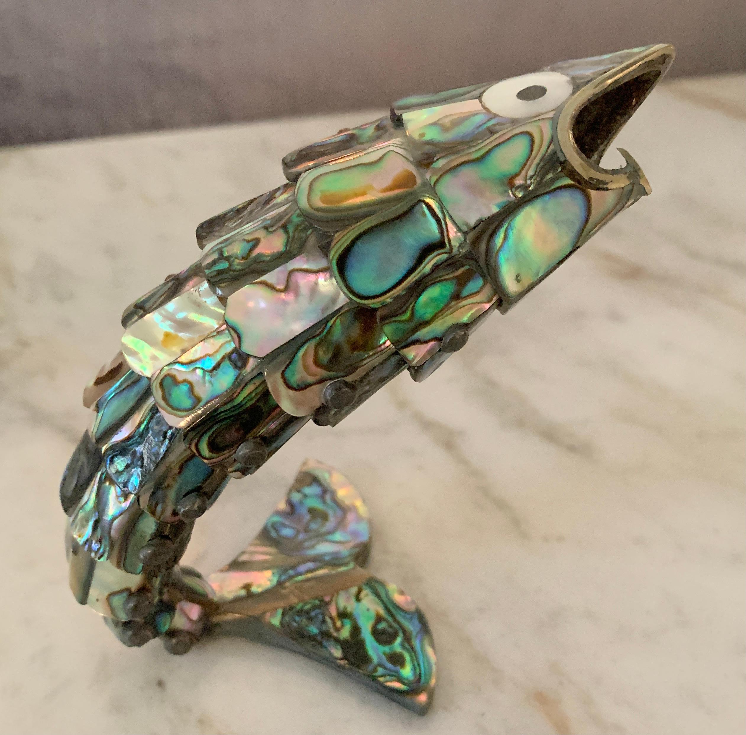 A wonderful mid century bottle opener in the style of Los Castillo. The opener is an iconic design and a compliment to any bar or kitchen counter. The piece can rest standing up on it's tail.