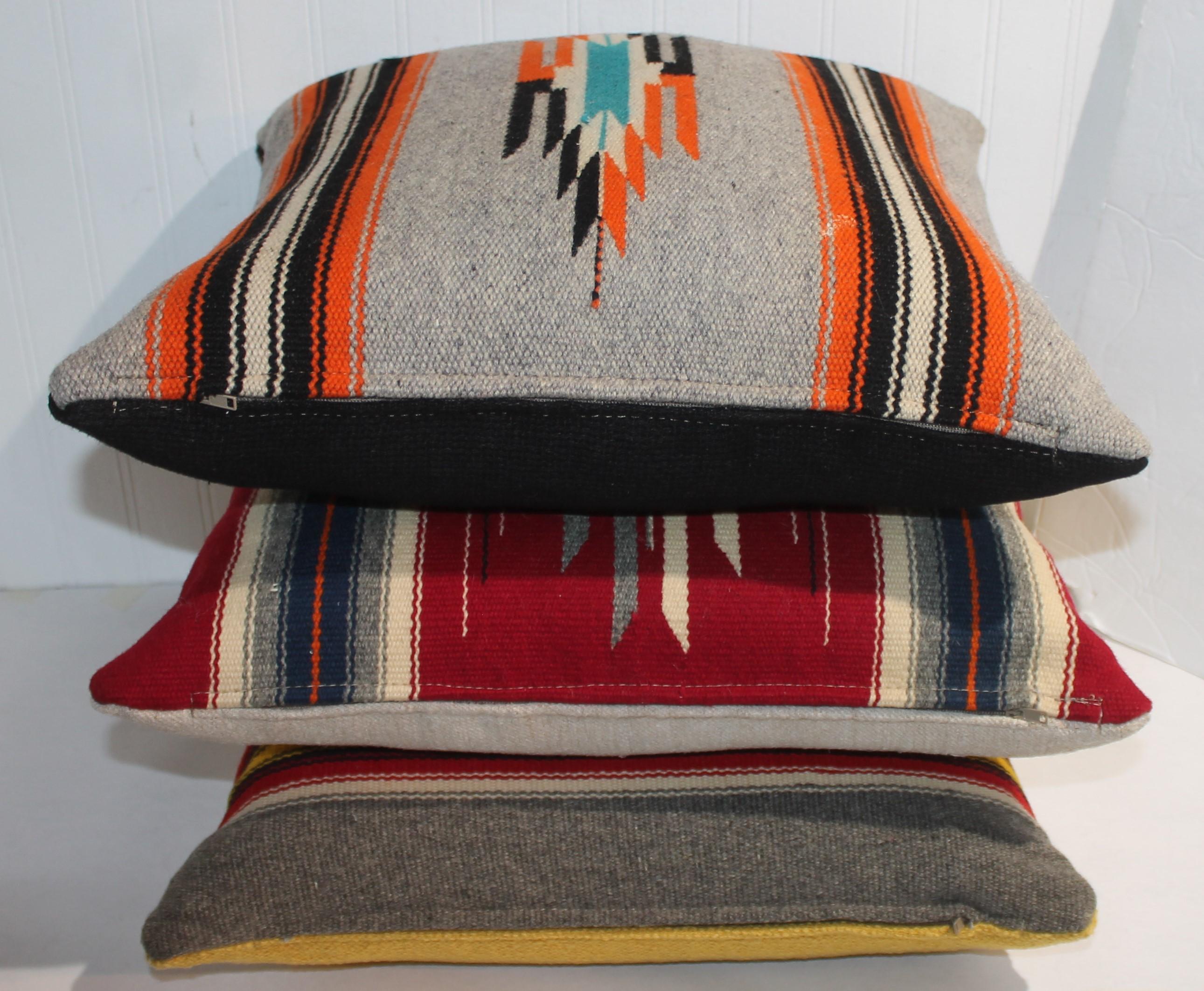 We are offering a group of three Mexican serape pillows with linen backings.The inserts are down & feather fill with zippers.