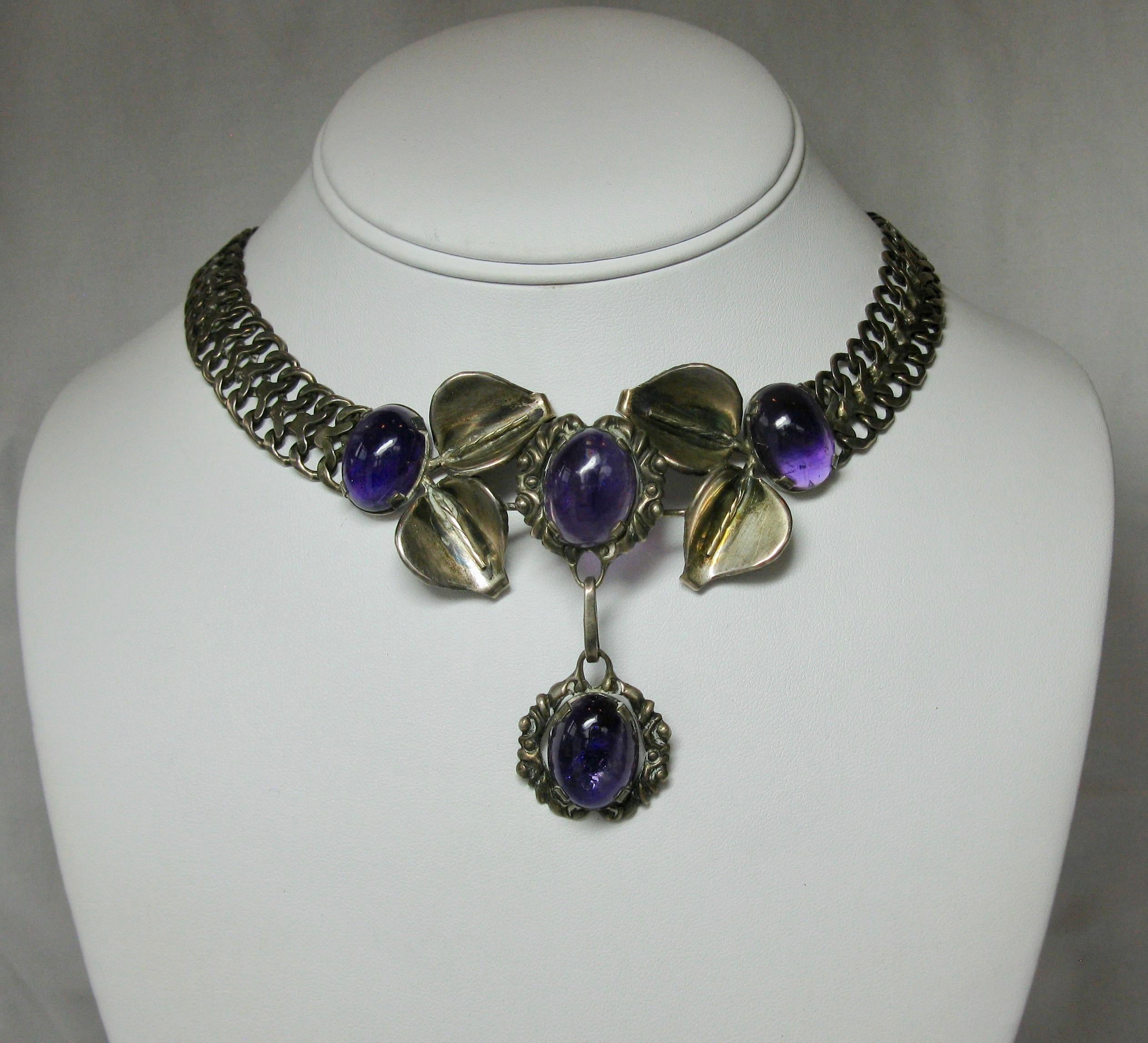 One of the finest Mexican Silver Amethyst Necklace and Earrings Suites.  The pieces are set with spectacular oval Amethyst cabochons in Sterling Silver.  The necklace is signed by the artist.  The Mid Century, Modern Jewels have a leaf motif design
