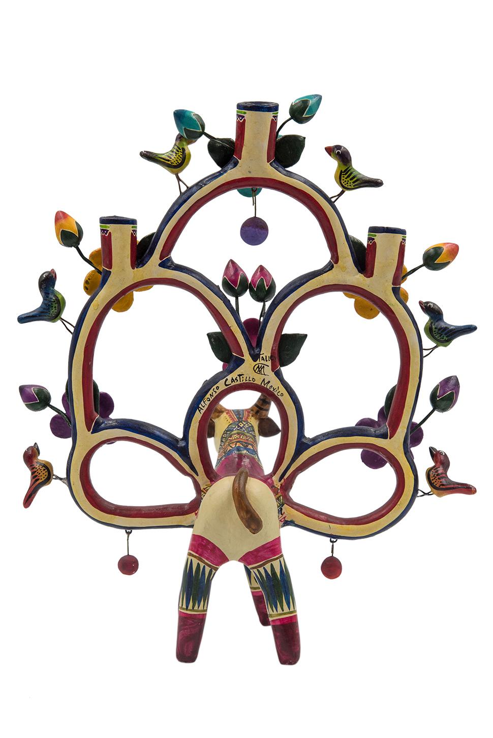 This colorful tree of life (árbol de la vida) with a toy like aspect is a unique piece by Marco Antonio Castillo, son of renowned artist Alfonso Castillo. Made with natural clay and painted with acrylic colors this piece is one of the few small