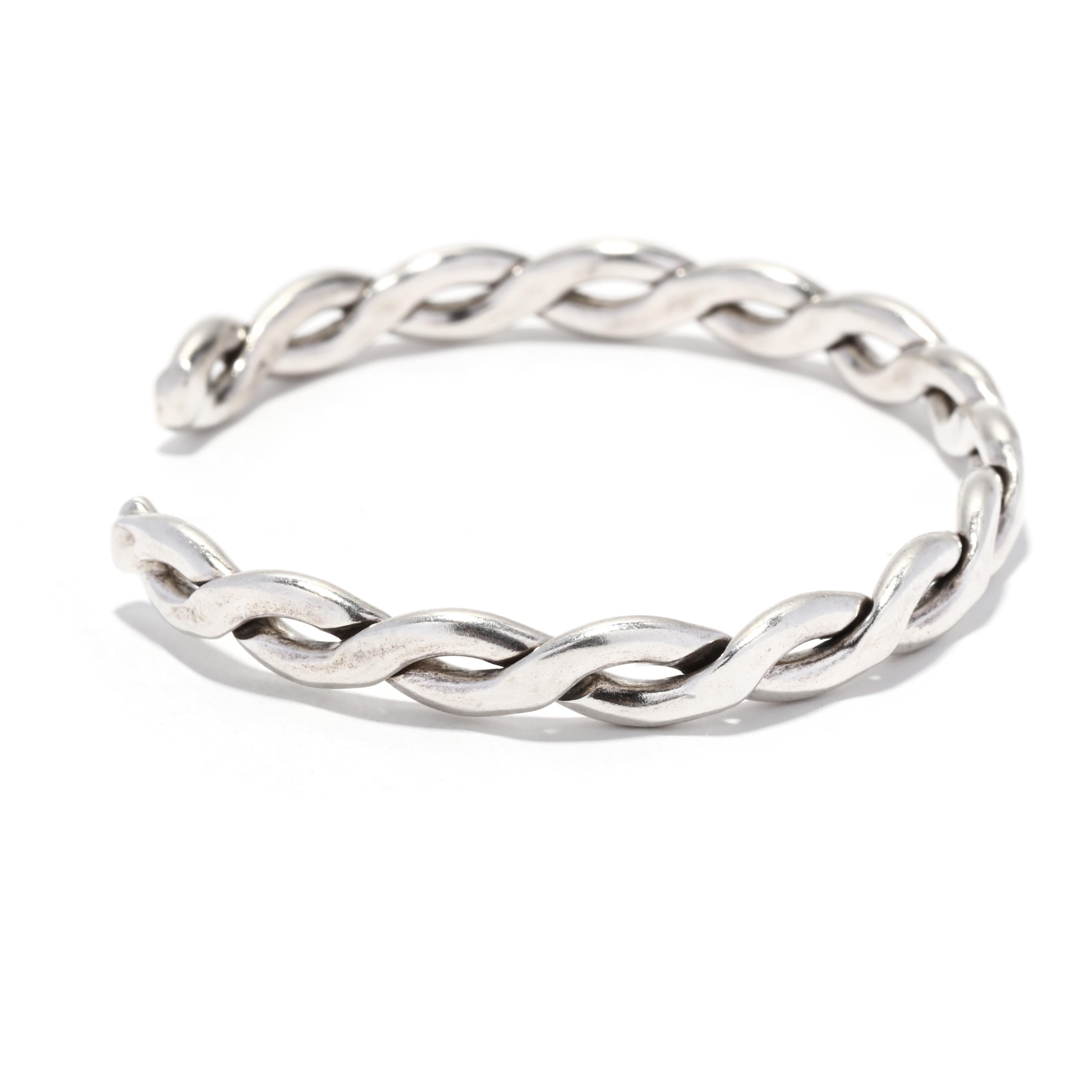 A vintage Mexican sterling silver braided cuff bracelet. This thin cuff bracelet features a flat braided motif.  It is stamped 925 Mexico.  

Interior circumference: 6.5 inches with a 7/8 inch opening

Width: 1/4 in.

Weight: 11.4 dwt. / 17.73
